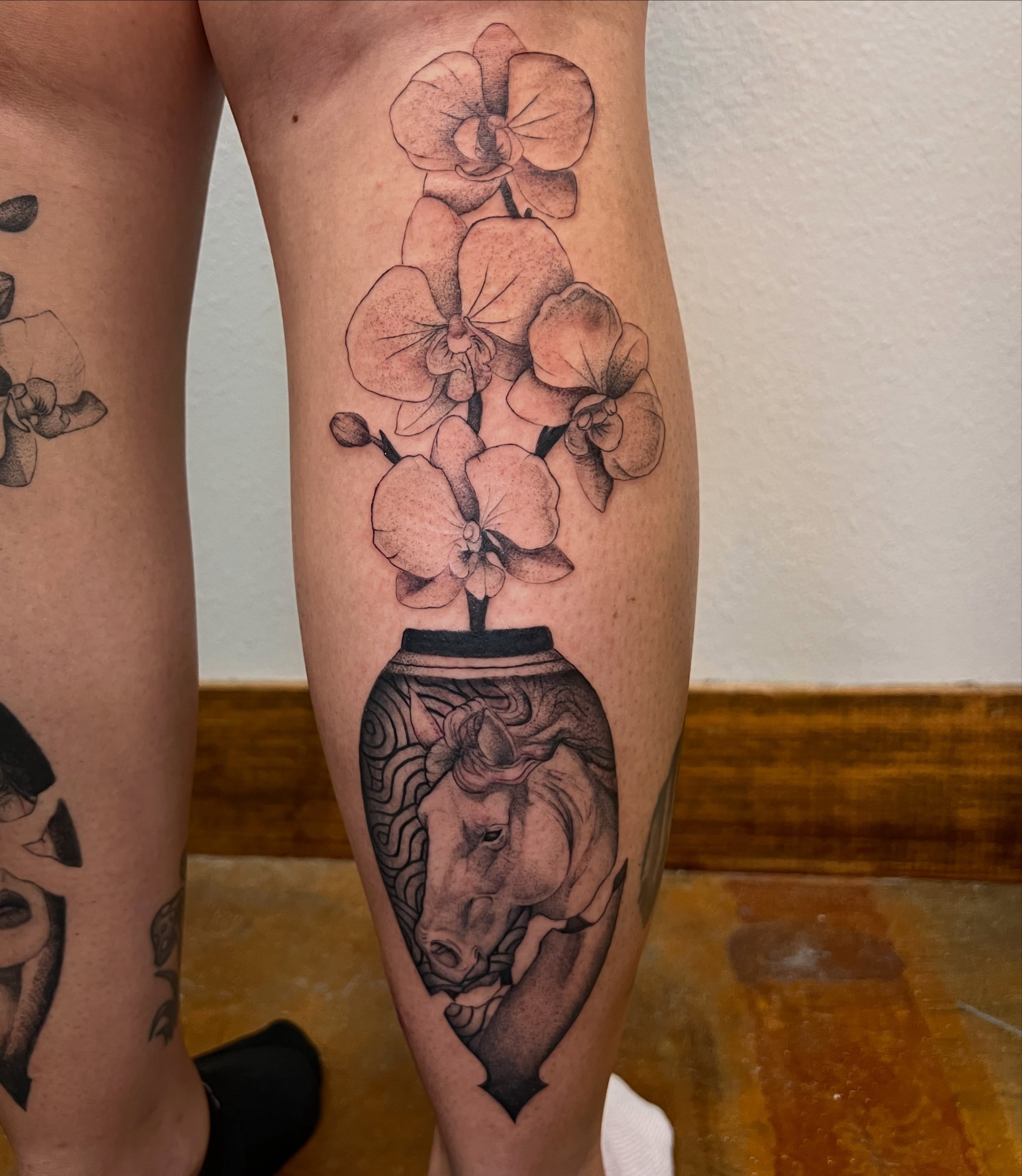 Orchids and horse realism tattoo on the calf by Rebecca Kern Tattoos