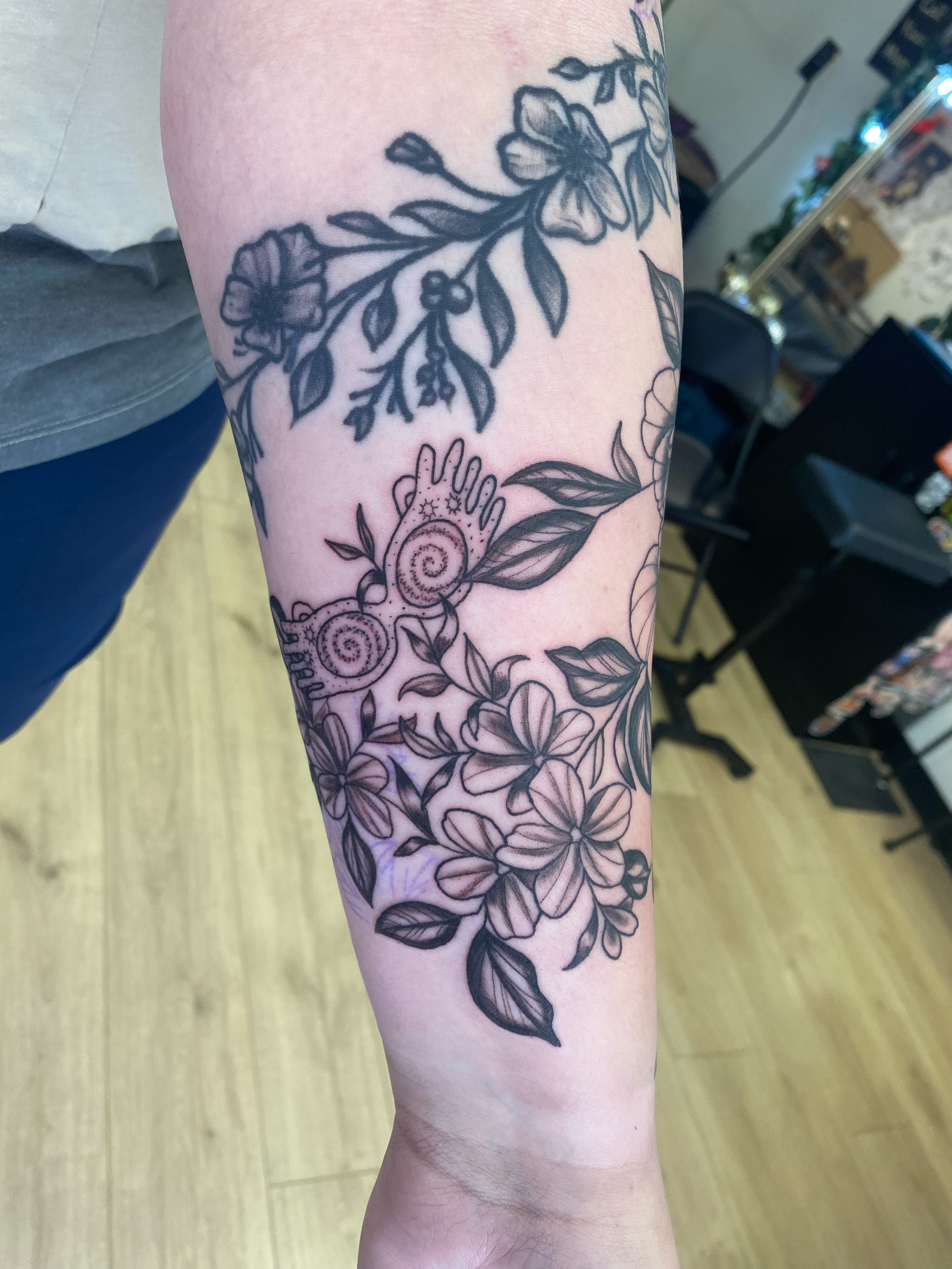 Floral arrangement ornamental tattoo on the forearm by Katie Leeper