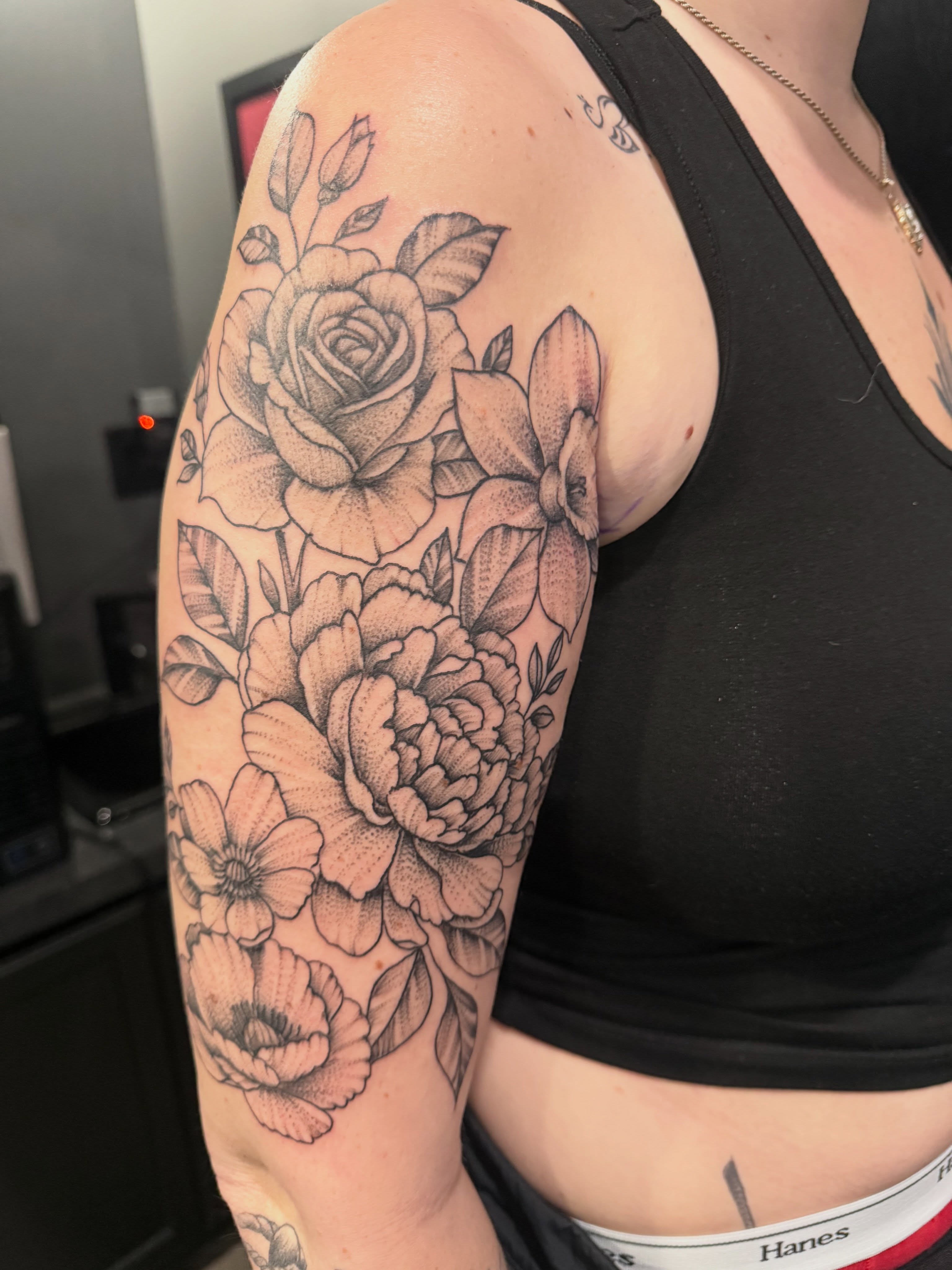 Floral bouquet dotwork tattoo on the upper arm by Dave Potavin, Erlanger, Kentucky