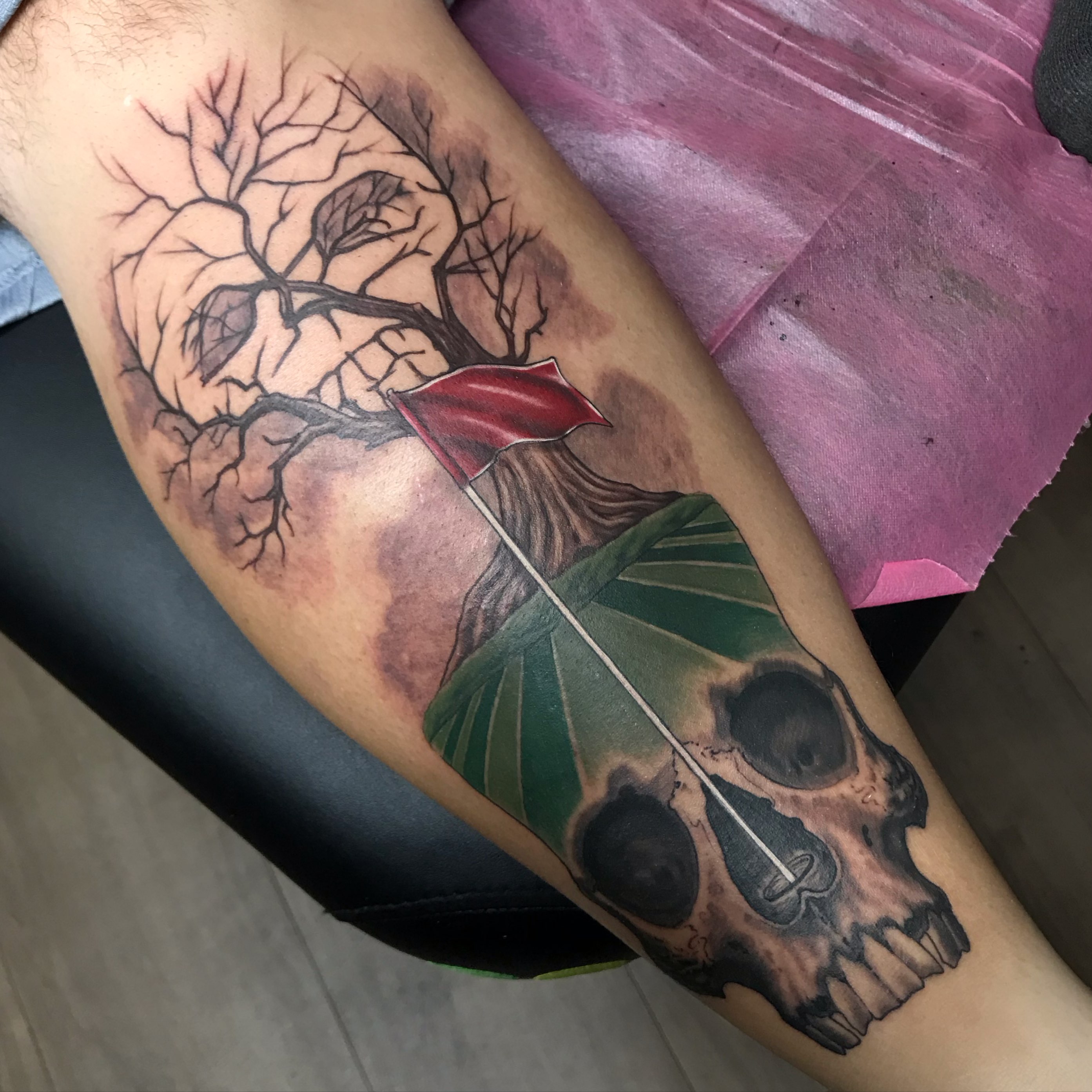 Skull and leaf realism tattoo on the forearm by Rick Rayne
