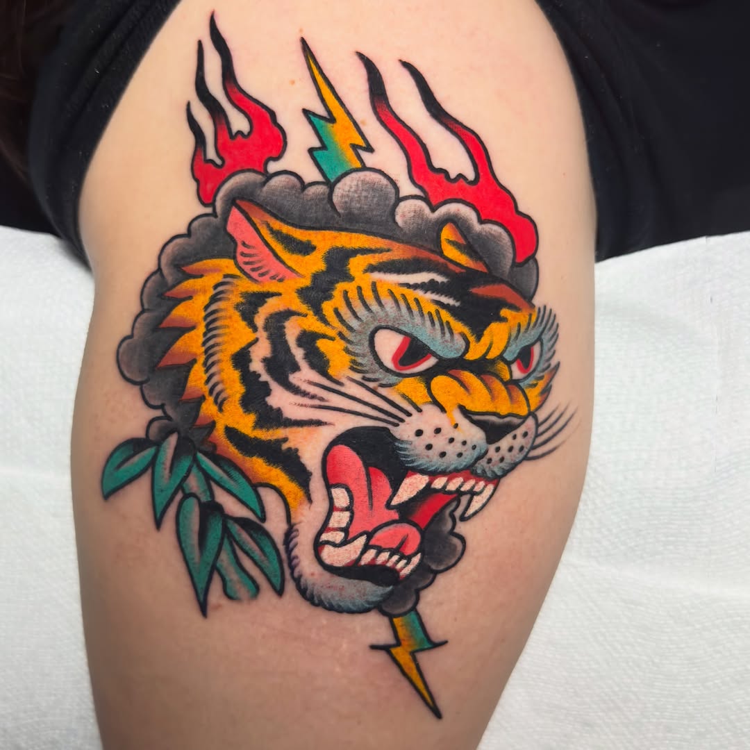 Tiger American traditional tattoo on the thigh by 𝐬𝐚𝐬𝐡𝐚 𝐯𝐚𝐧𝐝𝐚𝐥, Nashville, Tennessee