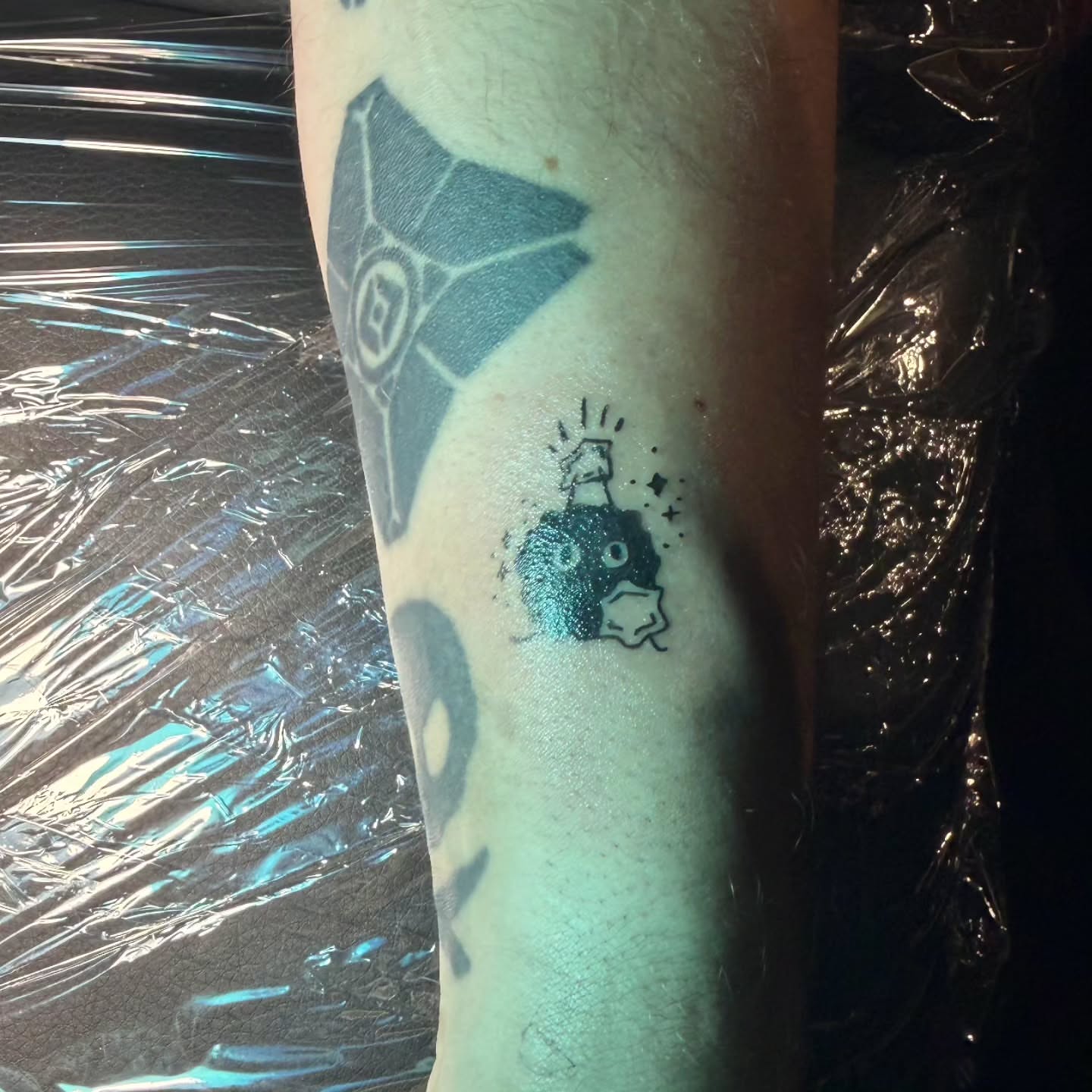Alien and spaceship geometric tattoo on the forearm by Bee