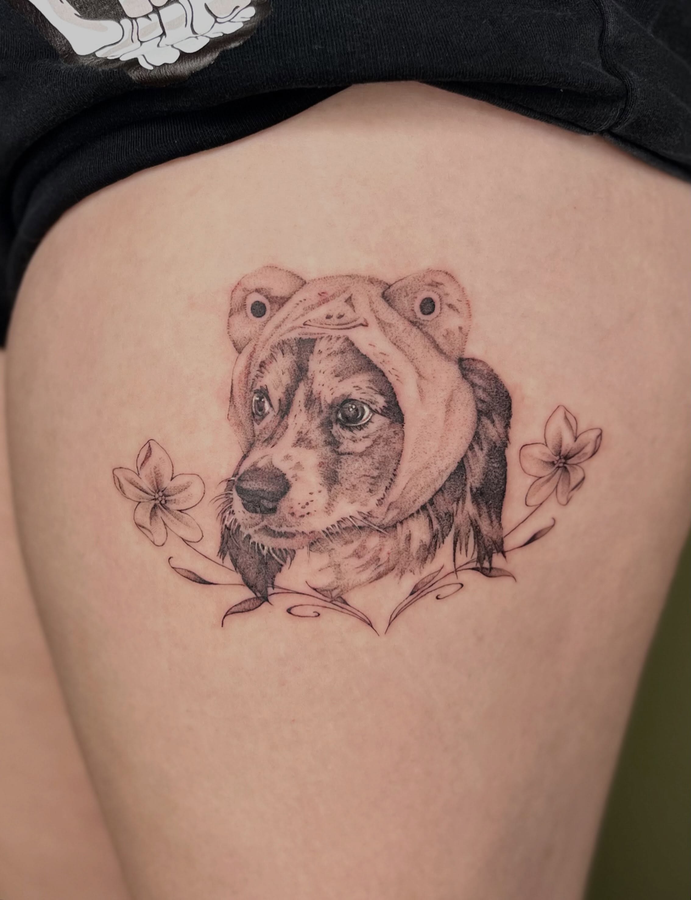 Dog with flowers realism tattoo on the thigh by Ash F