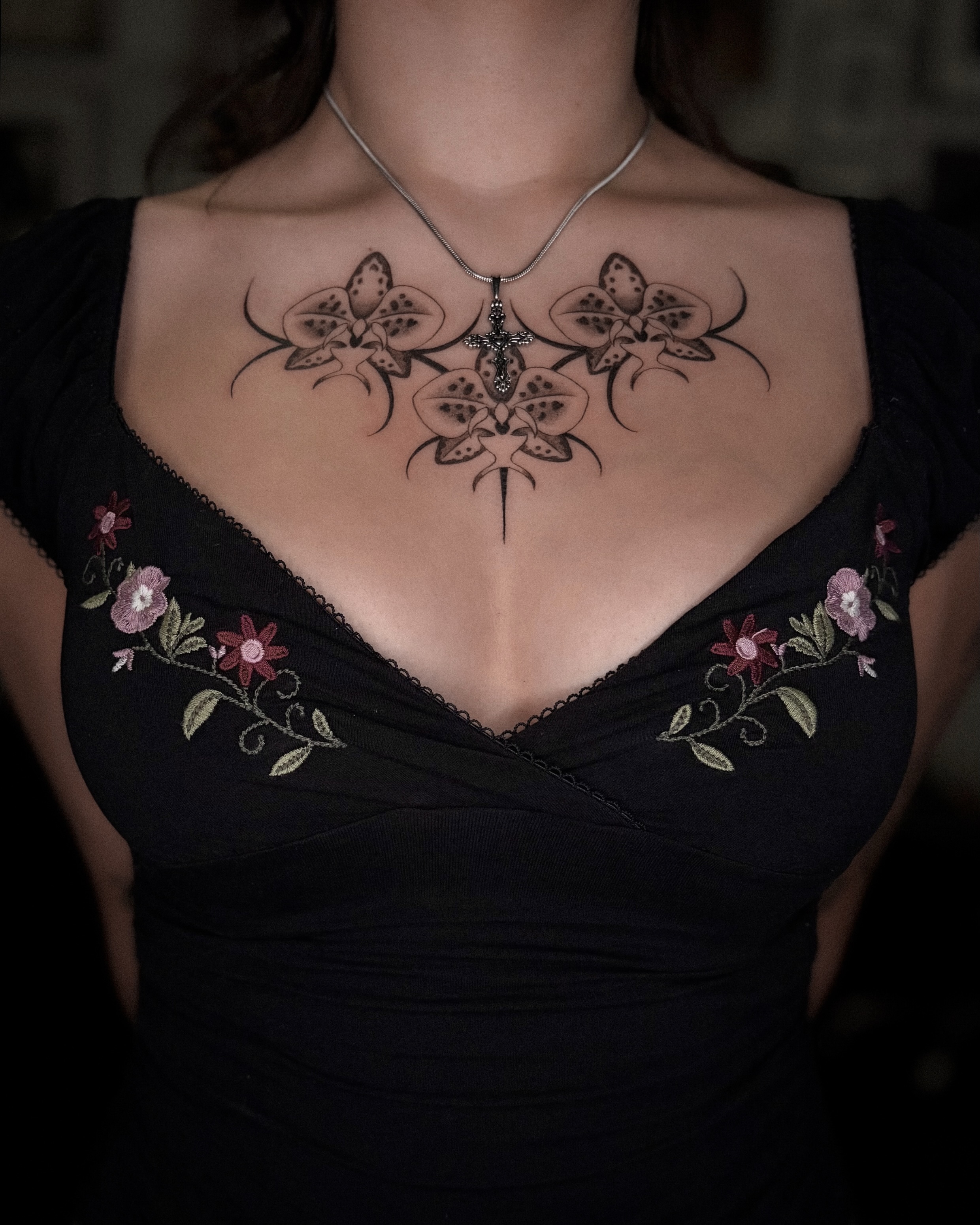 Cross with floral motifs black and grey tattoo on the chest by Tattoo Artist, in San Francisco, CA