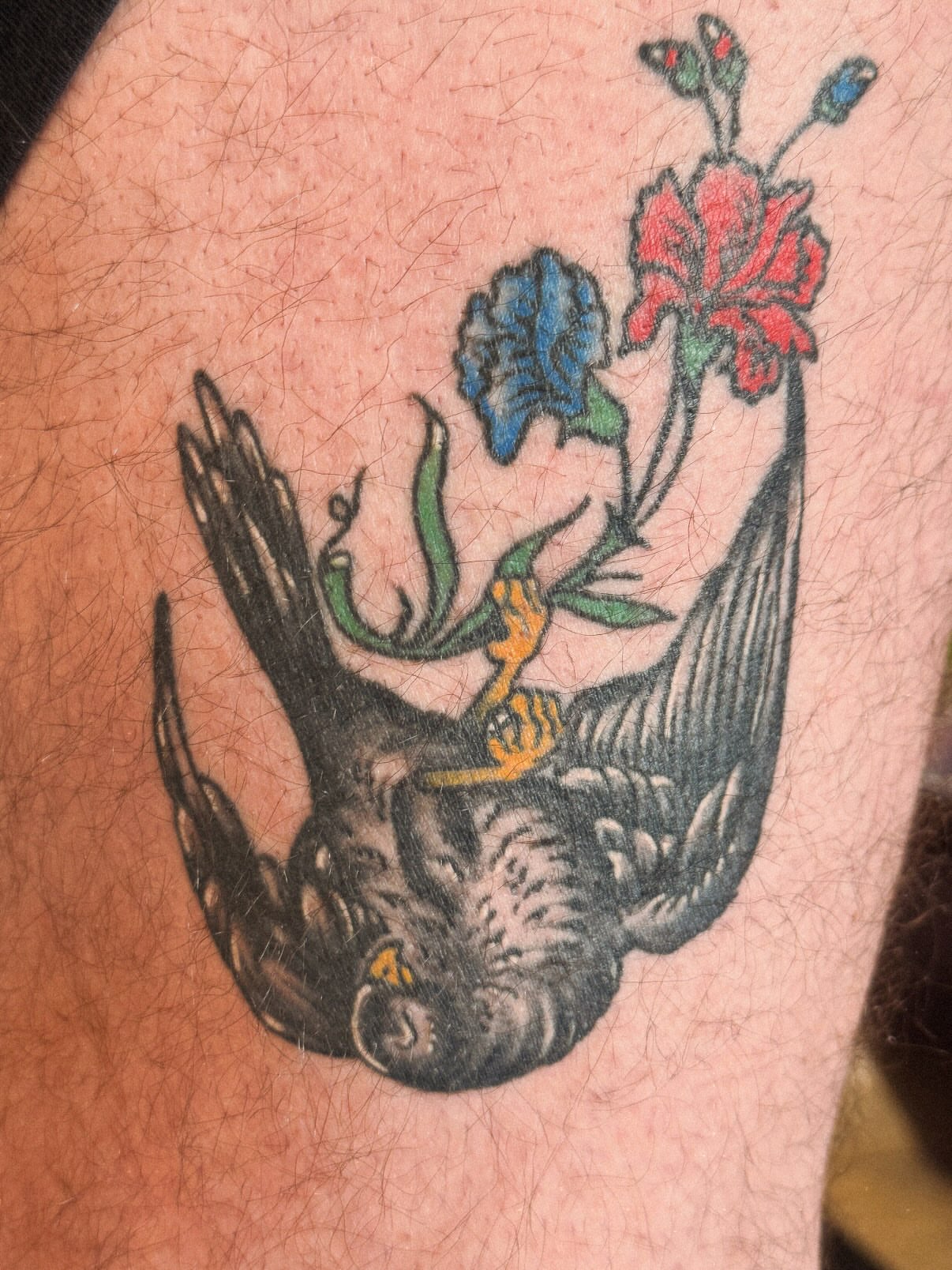 Bird and flowers American traditional tattoo on the forearm by Megan Sue Causemaker