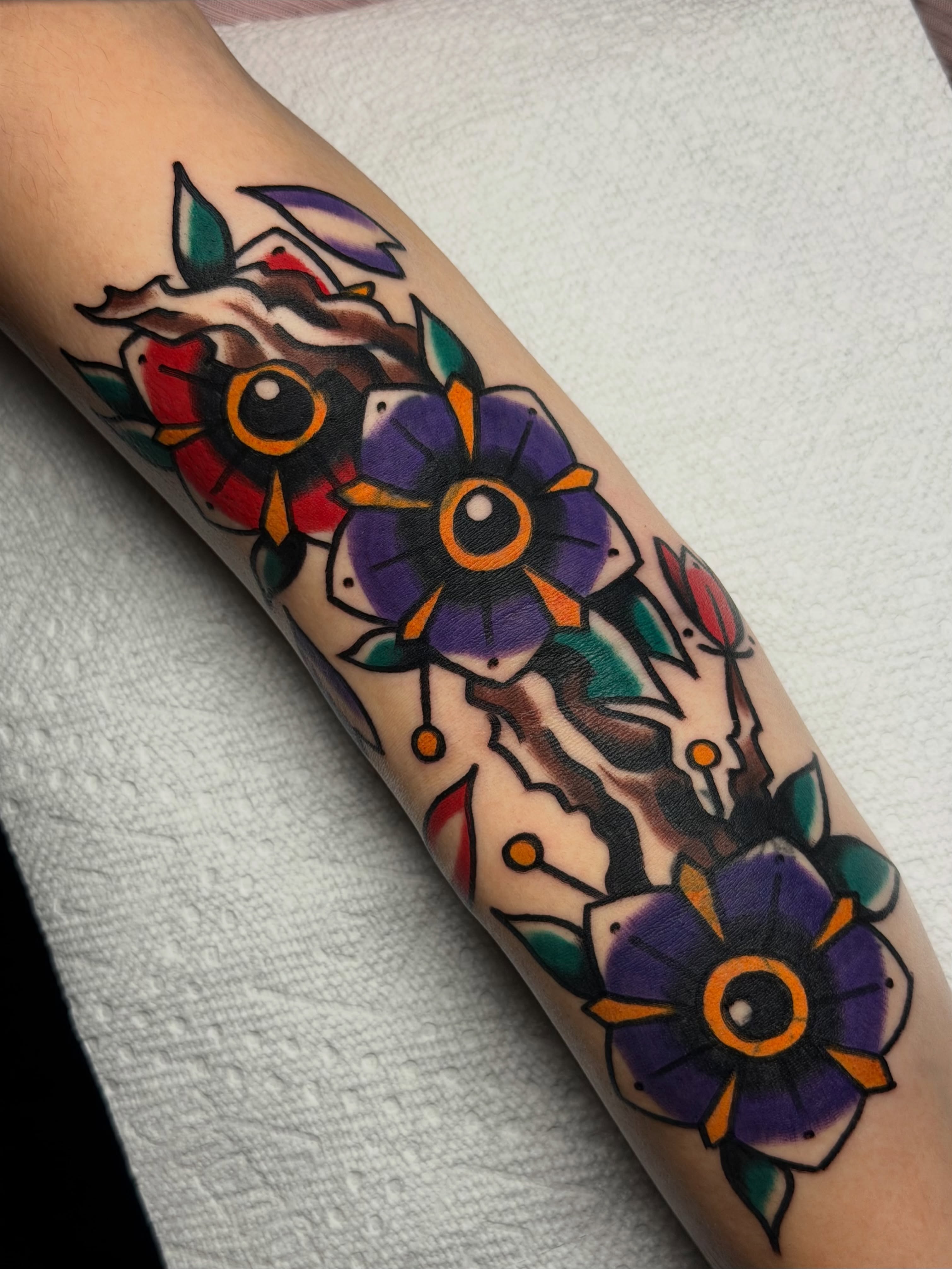 Flowers American traditional tattoo on the forearm by Kyle Dean Traditional Tattoo Artist