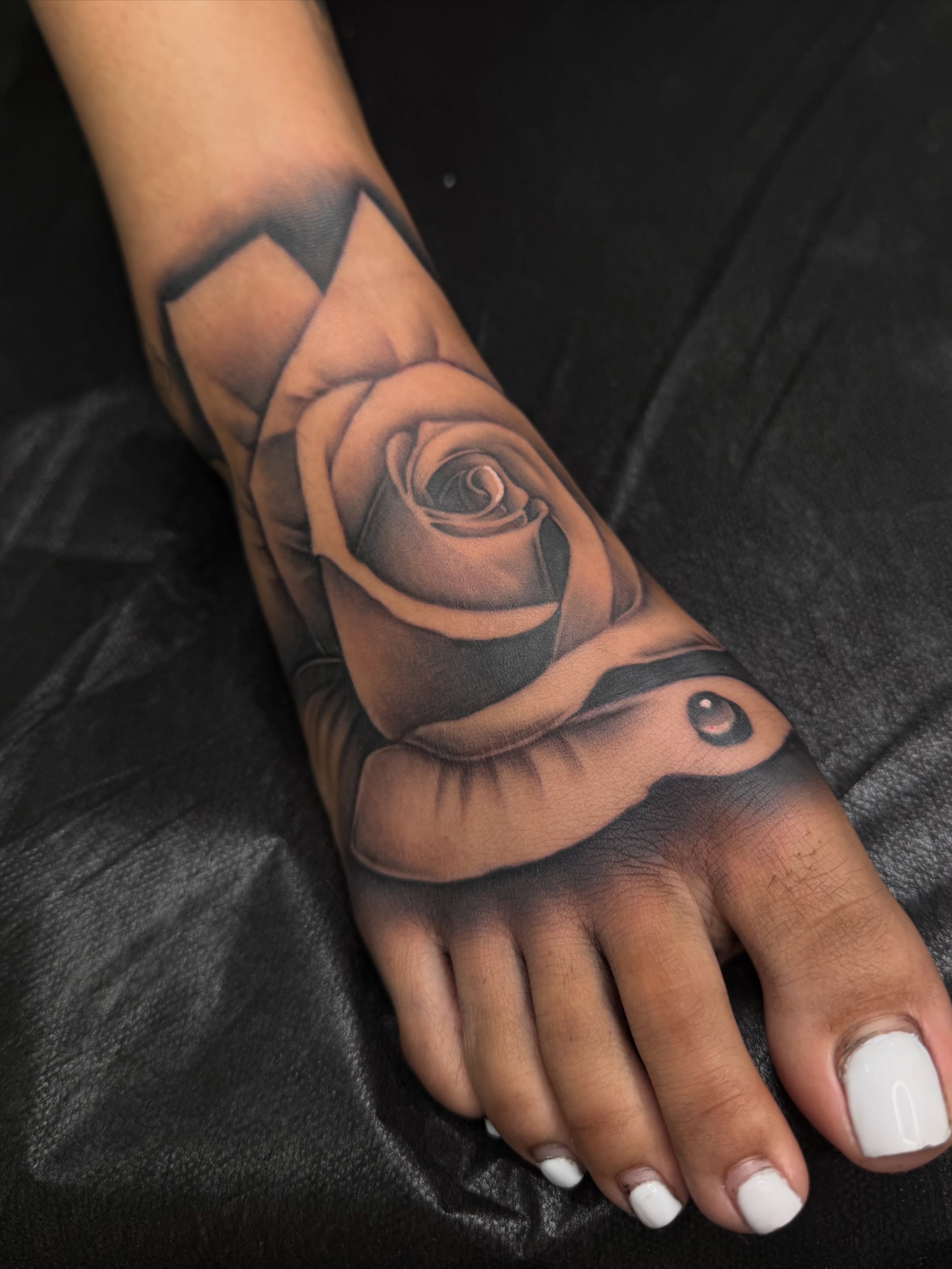 Rose black and grey tattoo on the foot by San Diego Tattoo Artist