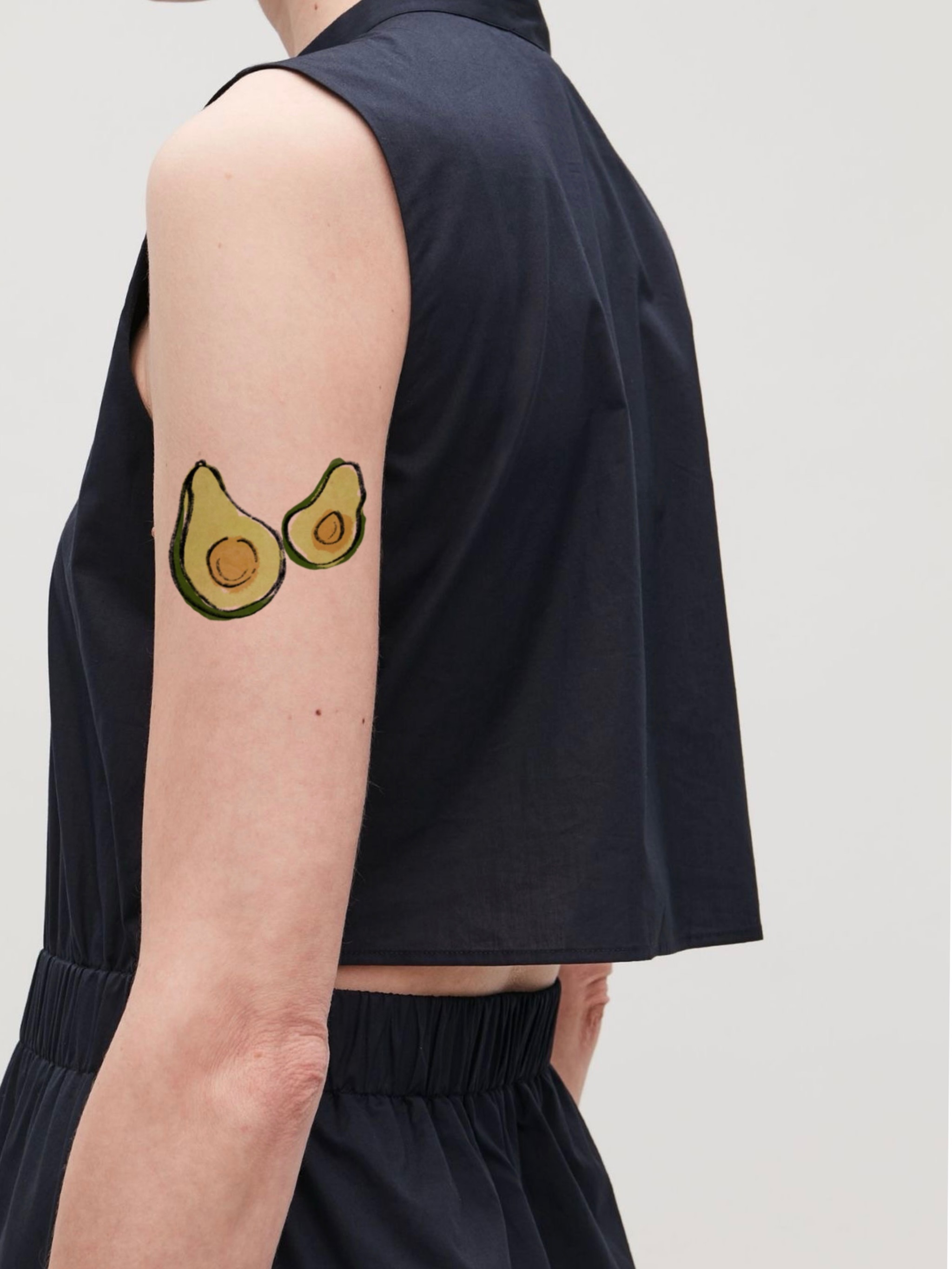 Avocado halves realism tattoo on the forearm by Ink _daisy_