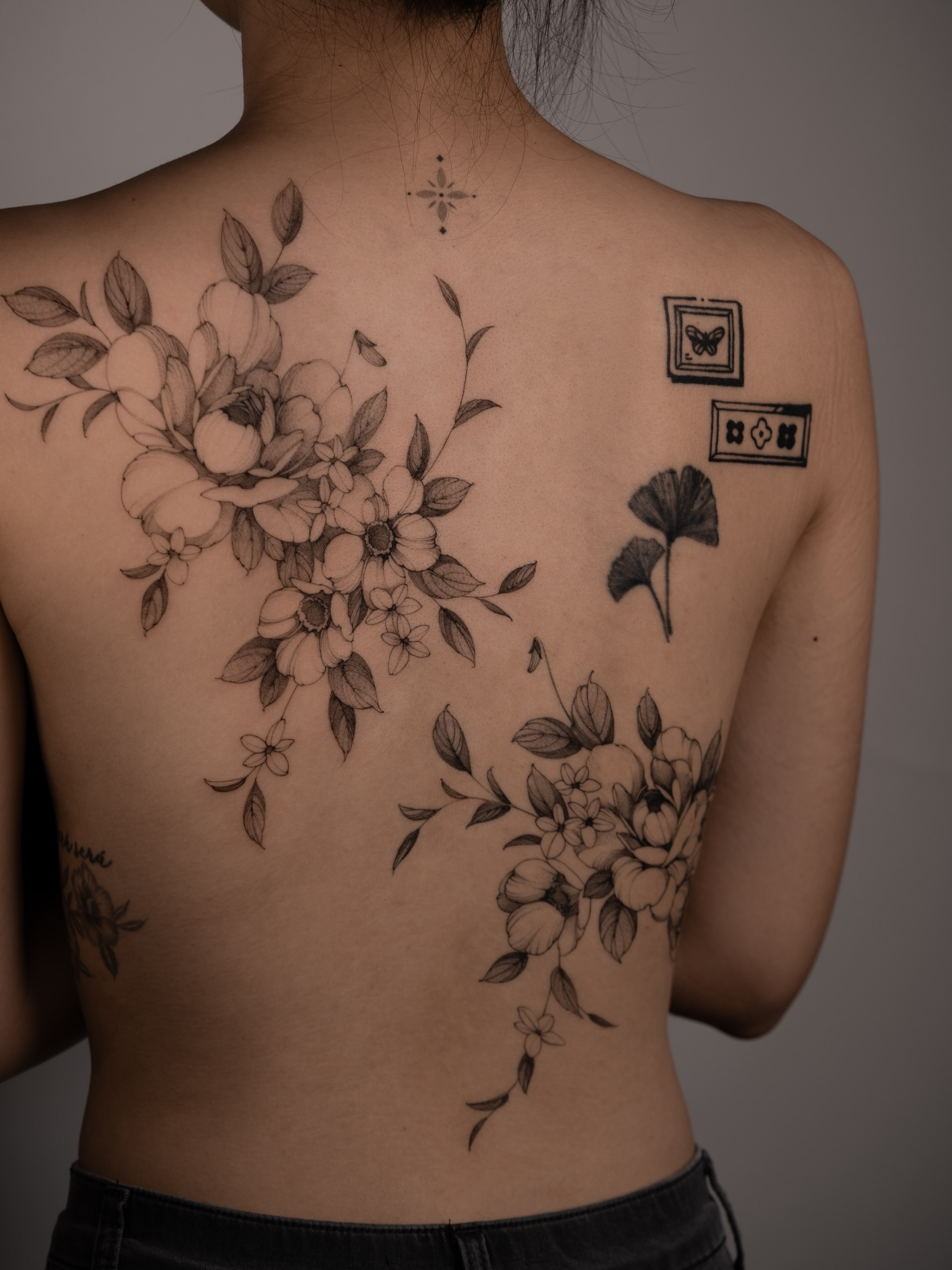Floral bouquet realism tattoo on the back by Mary Shekh