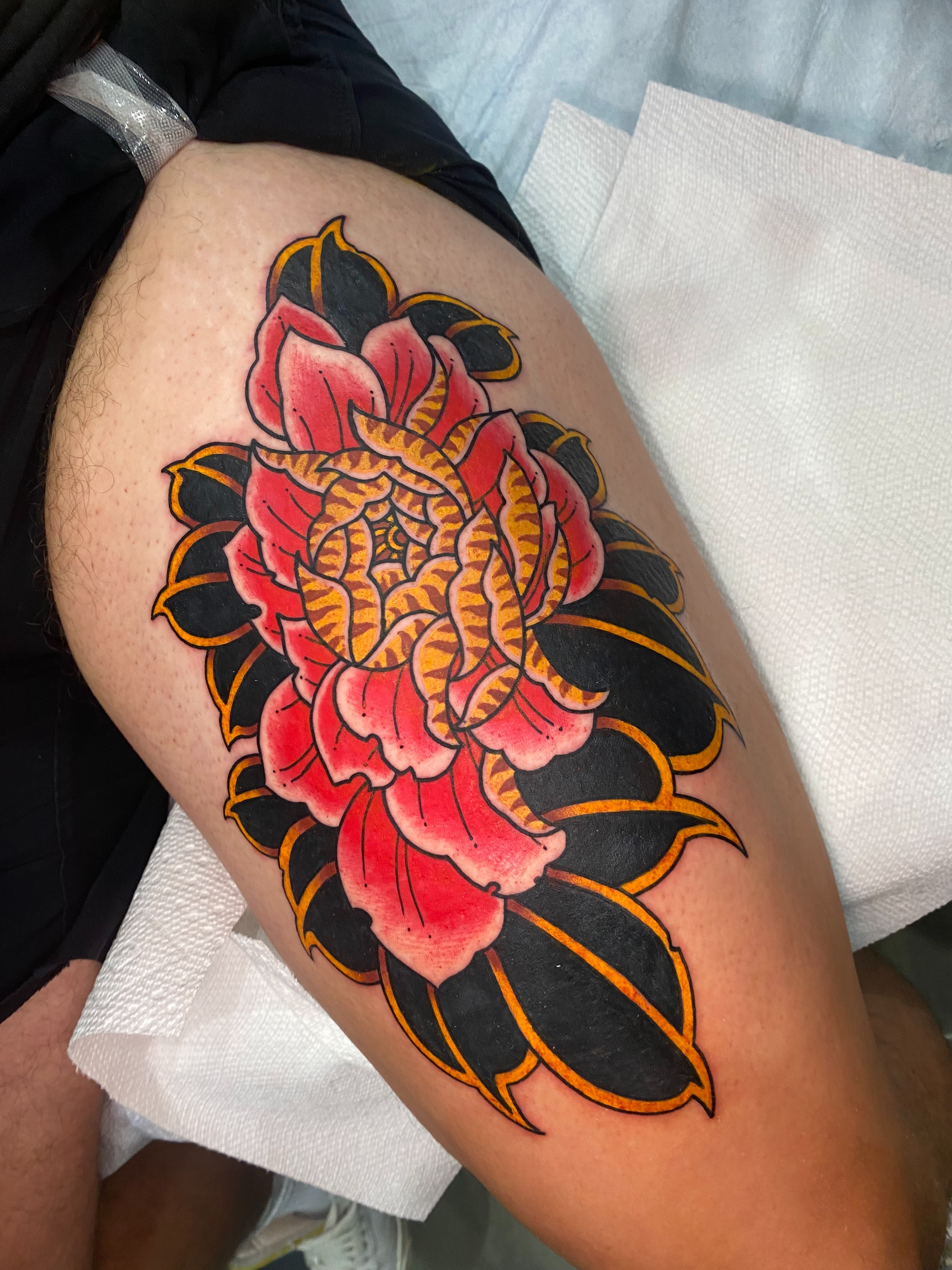 Lotus flower American traditional tattoo on the thigh by Nosferatu