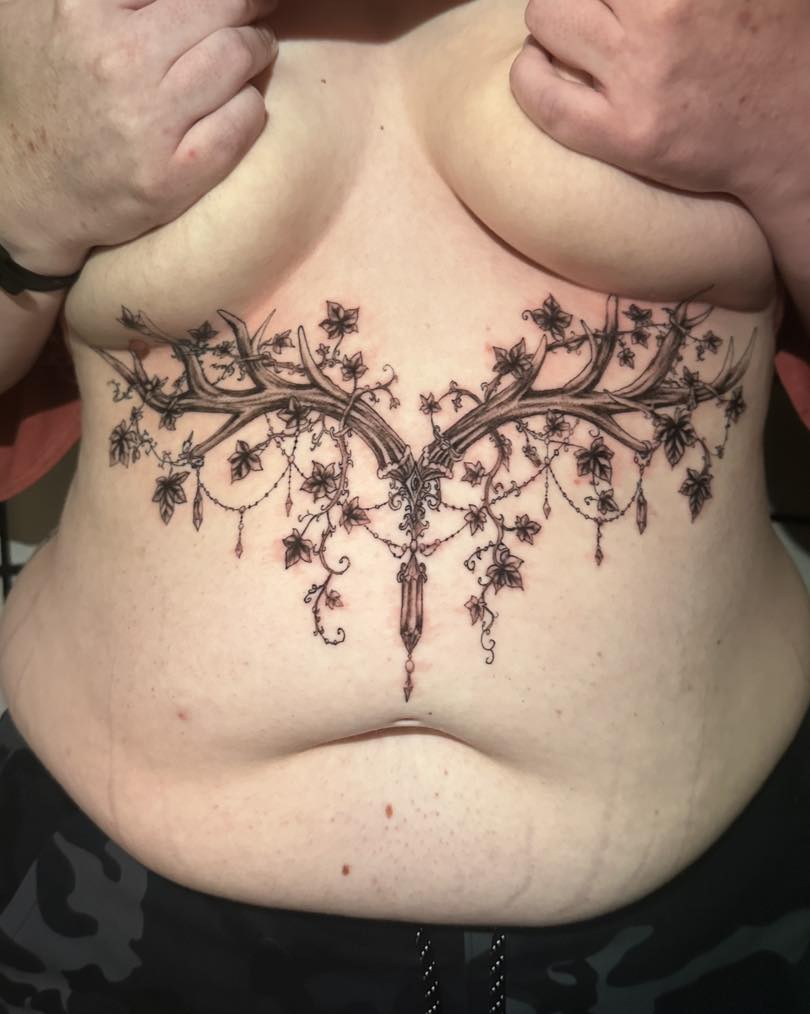 Antler chandelier ornamental tattoo on the chest by Chris Whittaker Tattoo Artist