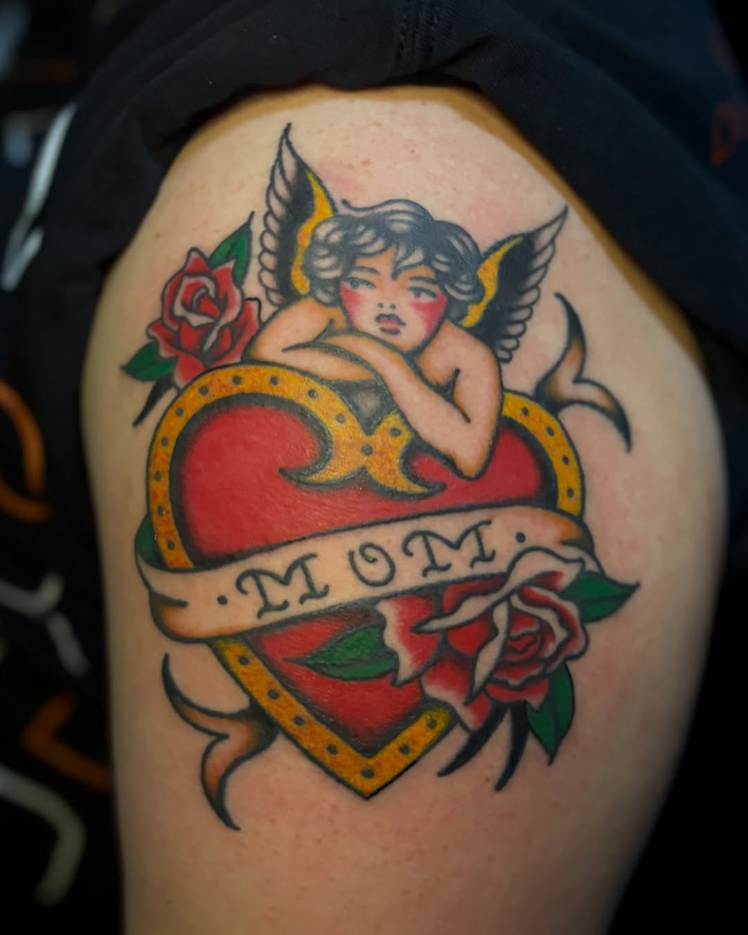Angelic cherub with heart American traditional tattoo on the shoulder by Tia Cave