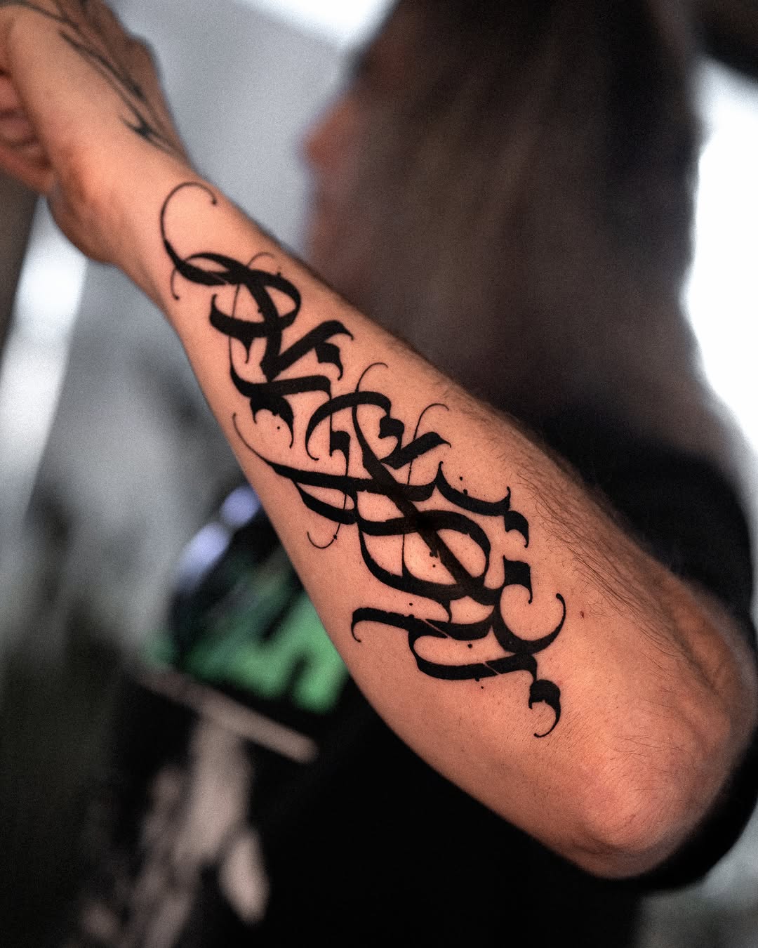 Calligraphy script lettering tattoo on the forearm by Low, Brooklyn, New York