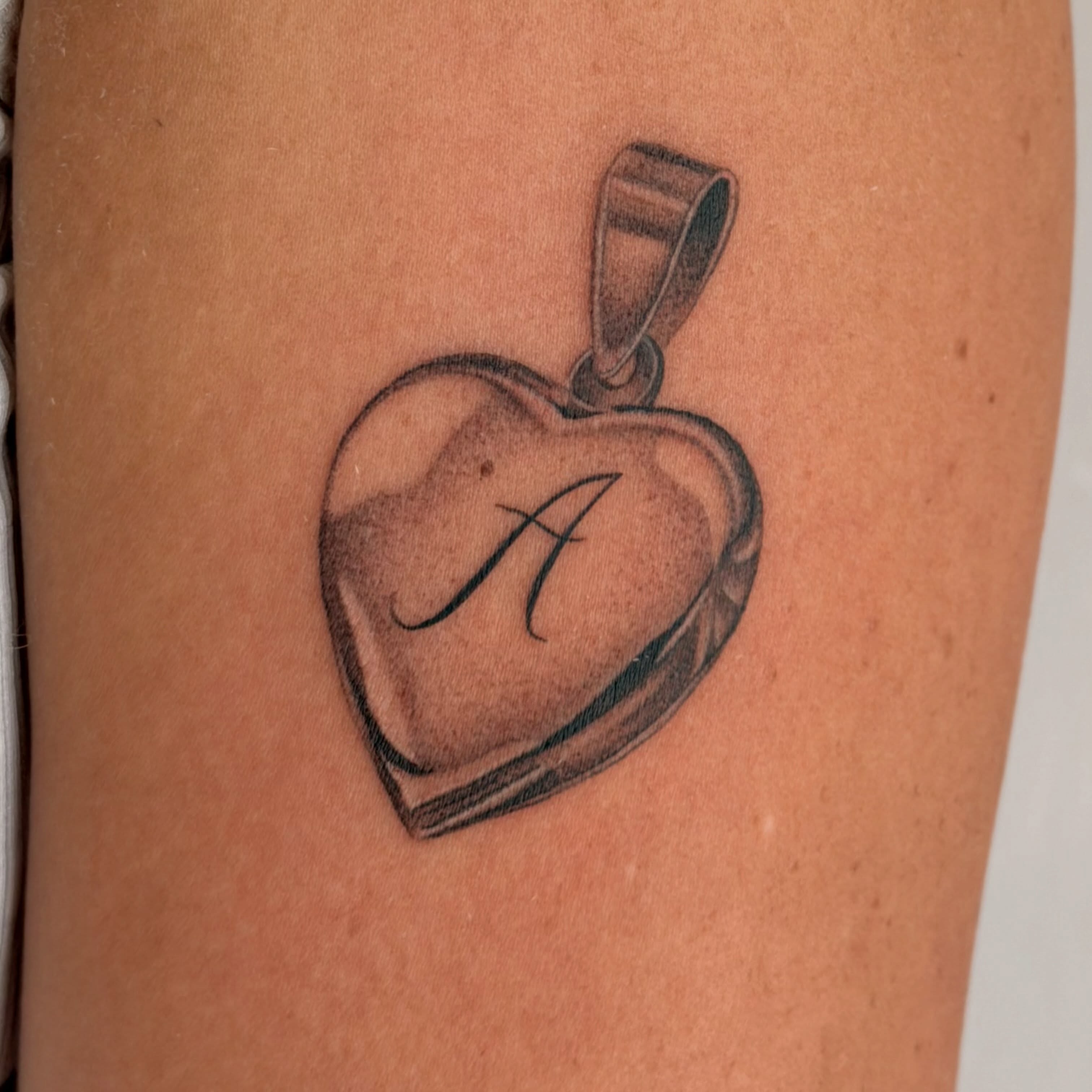 Heart pendant black and grey tattoo on the thigh by 🌼DaisyDaiz🕸️