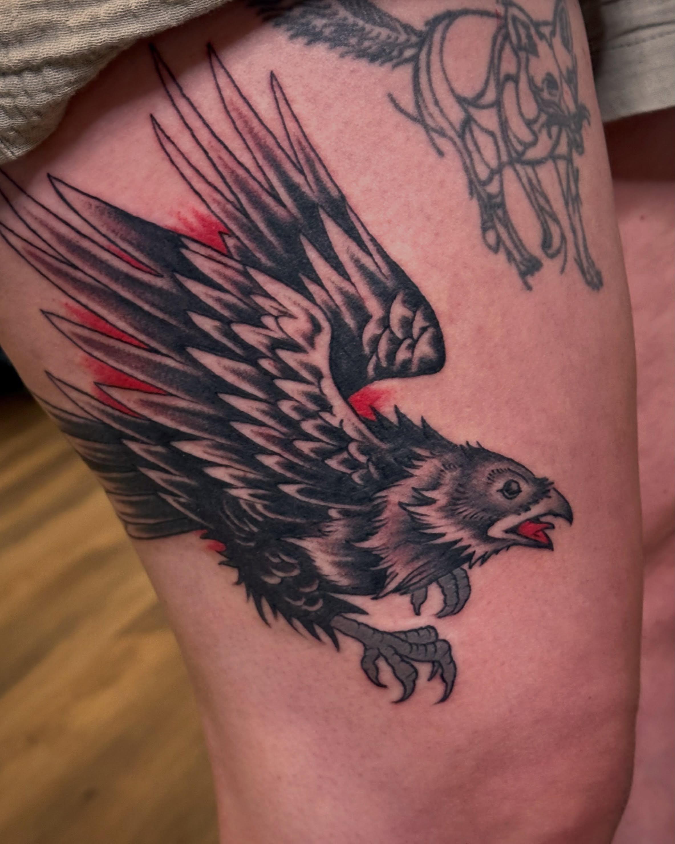 Eagle black and grey tattoo on the thigh by Craig Ryans
