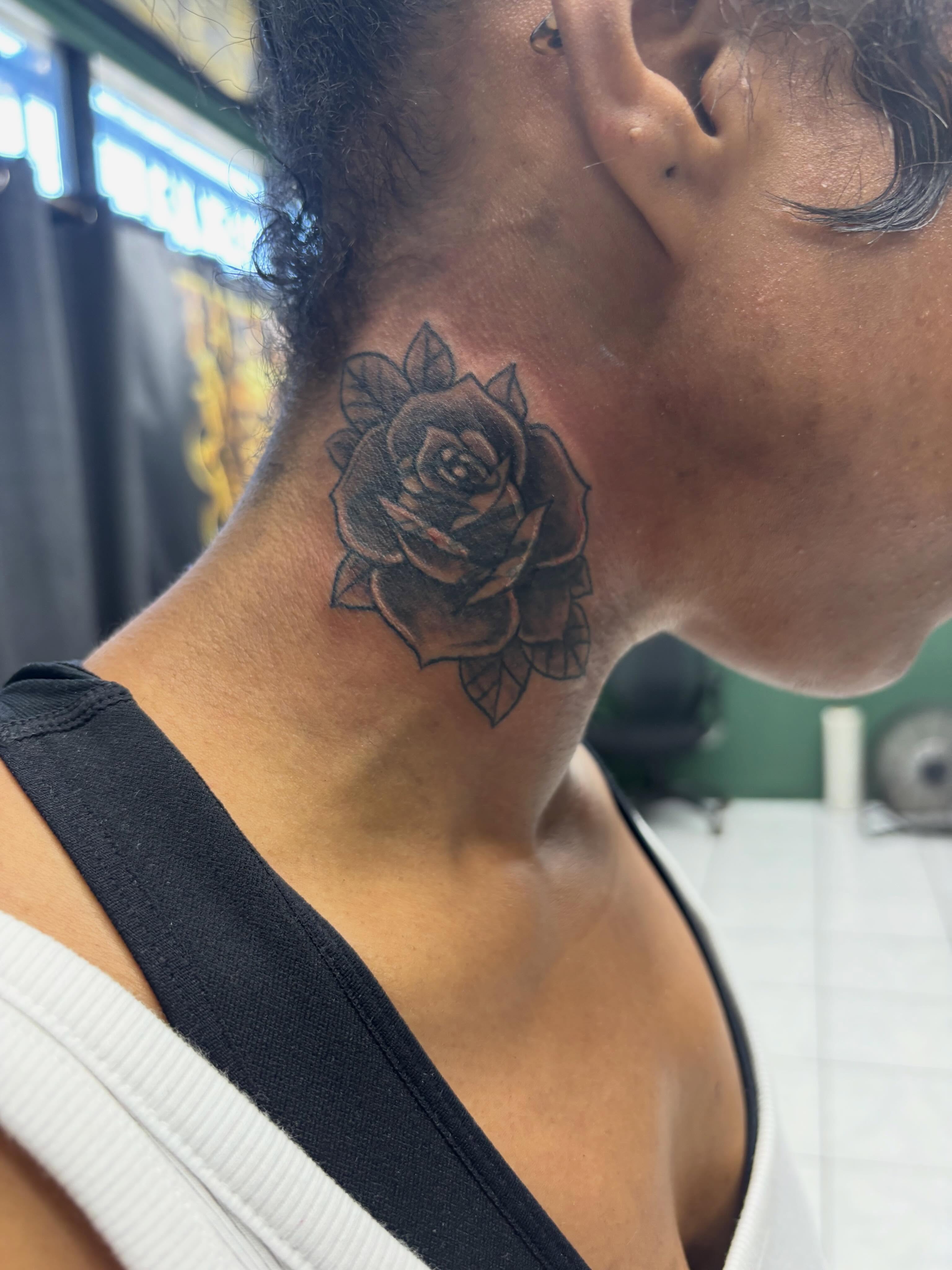 Rose black and grey tattoo on the neck by Shadows Tattoos