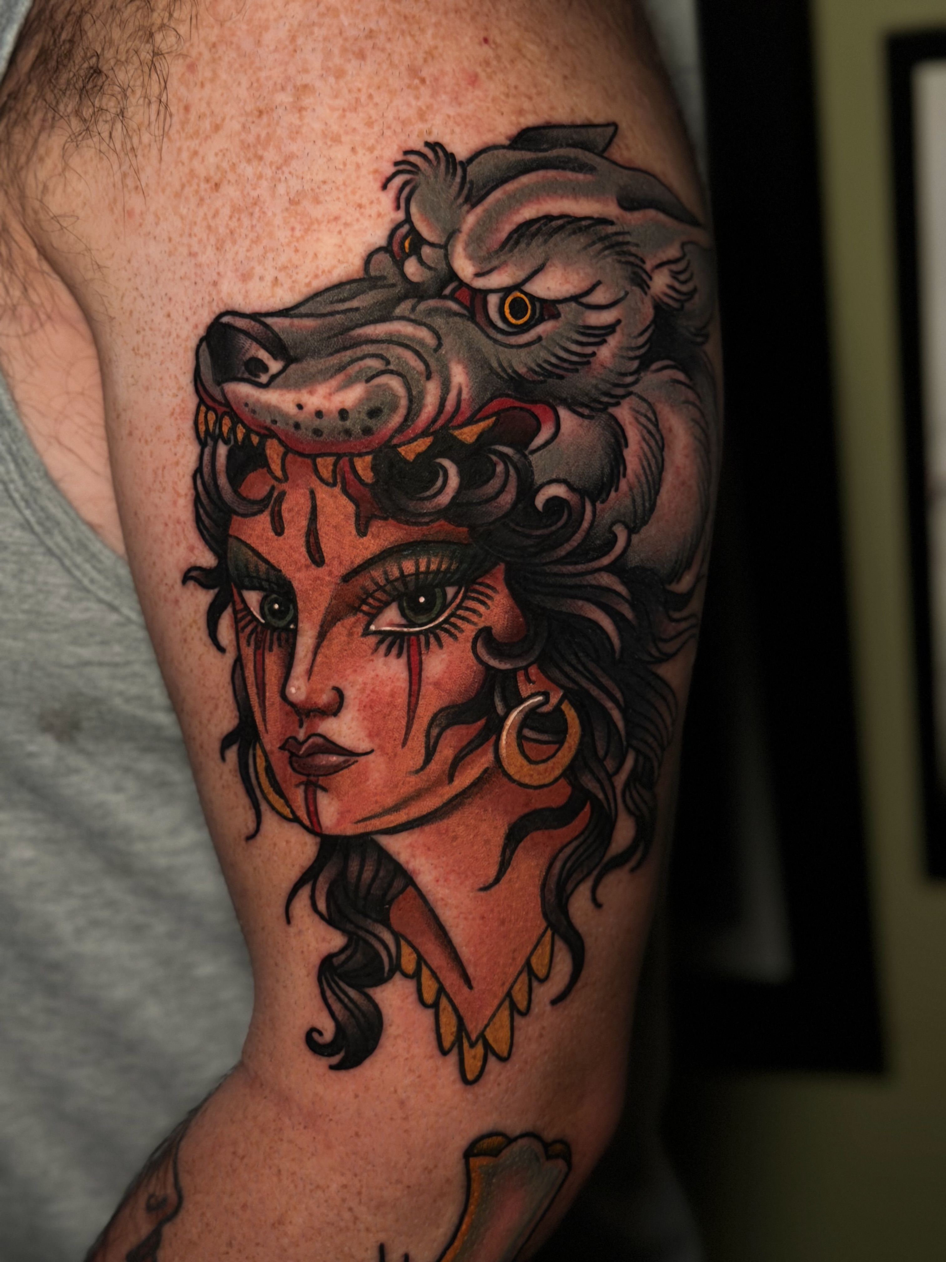 Woman with wolf head American traditional tattoo on the forearm by Cory Cartwright