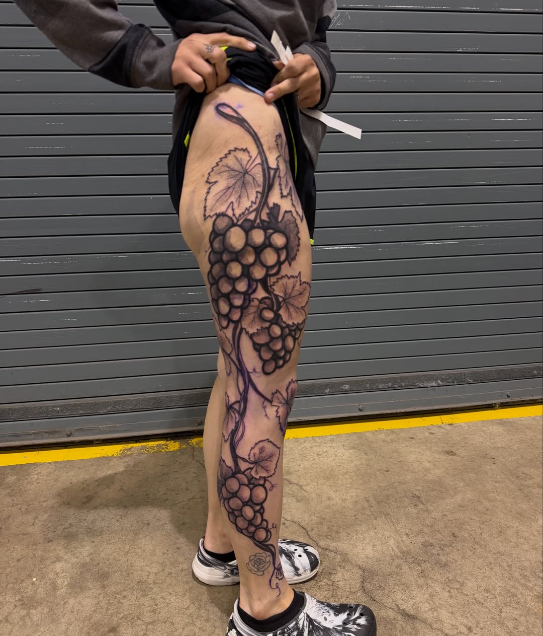 Grapes and leaves black and grey tattoo on the leg by Abbie Kaitlynn Taylor, Dayton, Ohio