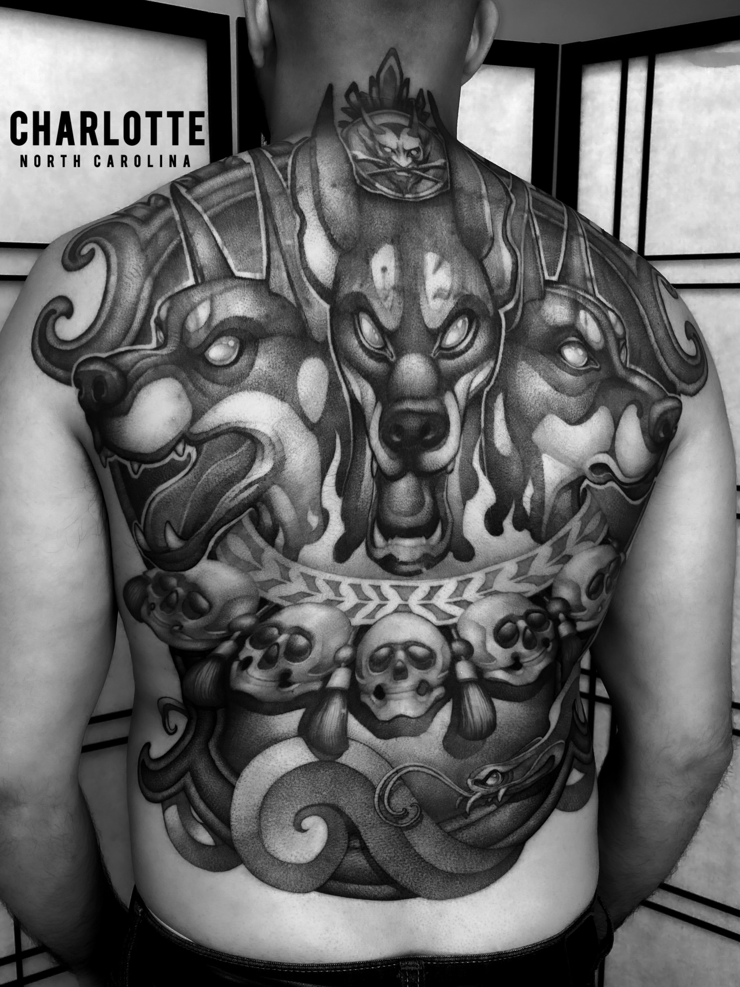 Lion and skulls realism tattoo on the chest by Tattoo artist in Charlotte,NC