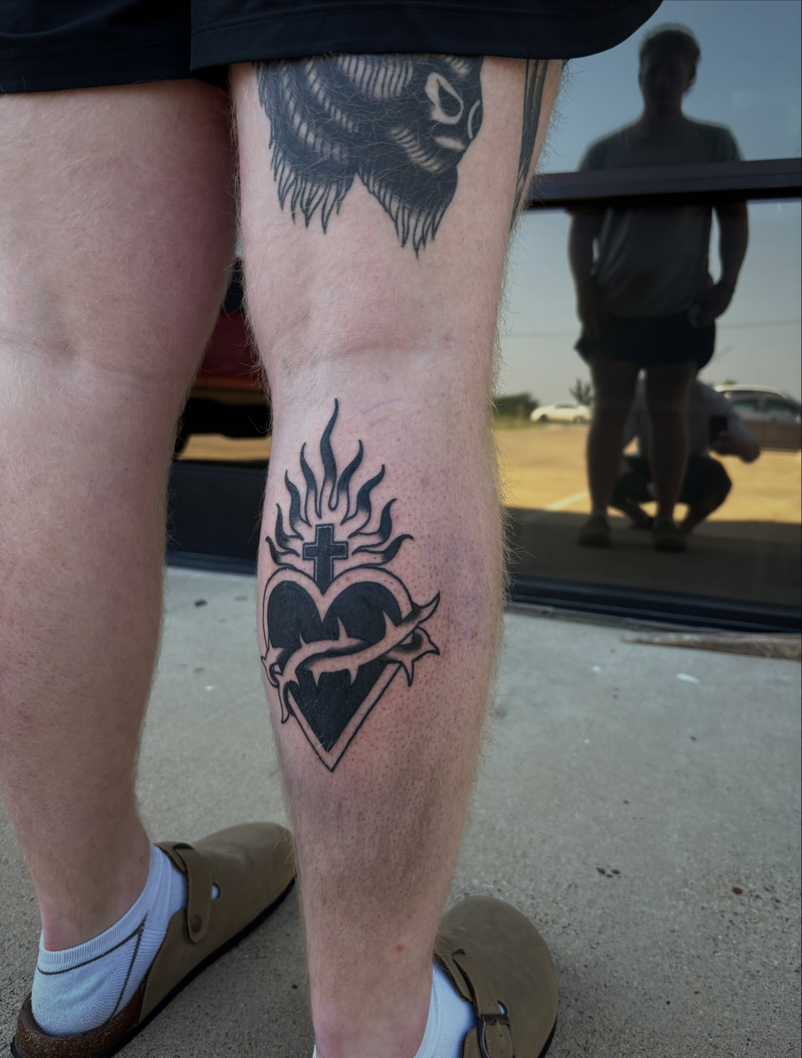 Heart with cross and thorns black and grey tattoo on the calf by Ethan Ellis, Dallas, Texas