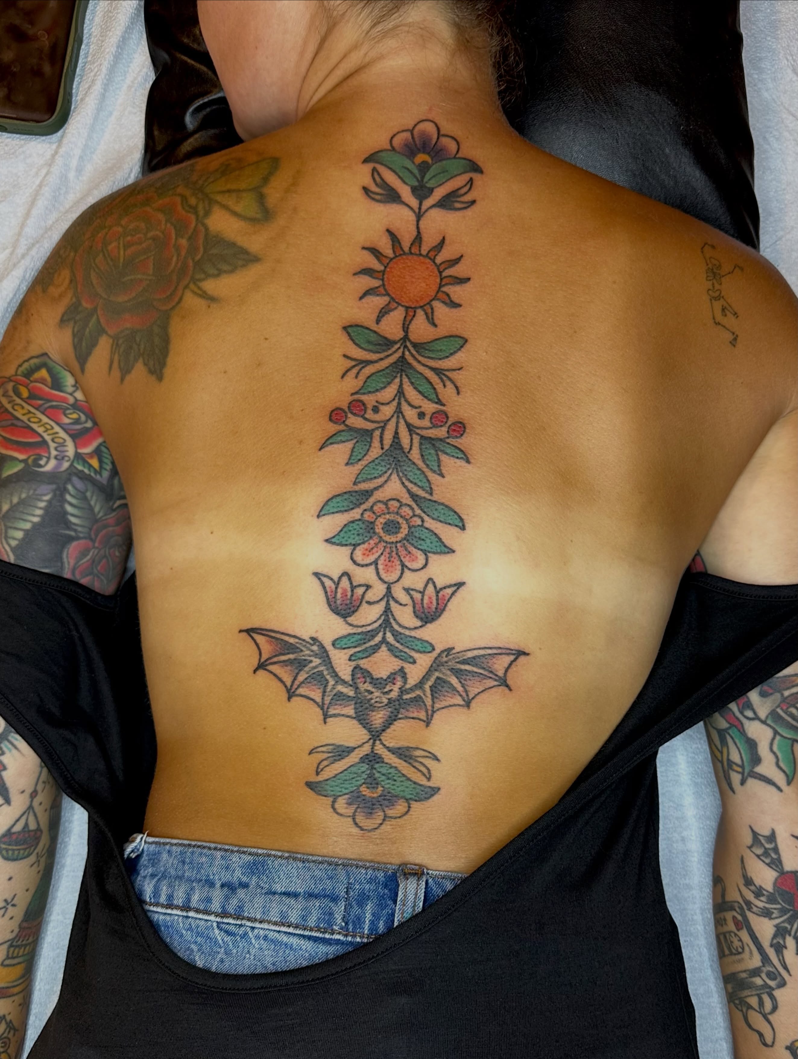 Bat and floral American traditional tattoo on the back by teddy, Portland, Oregon