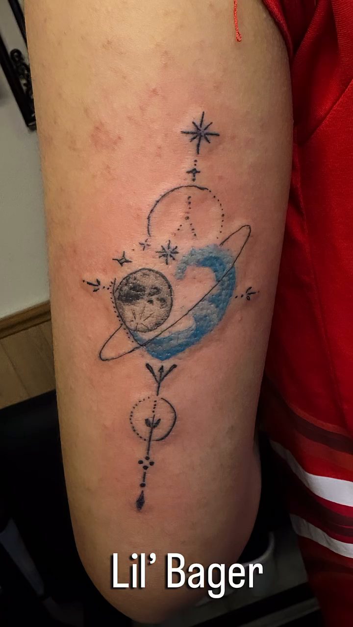 Celestial elements and moon tattoo on the upper arm by Engel Zurc