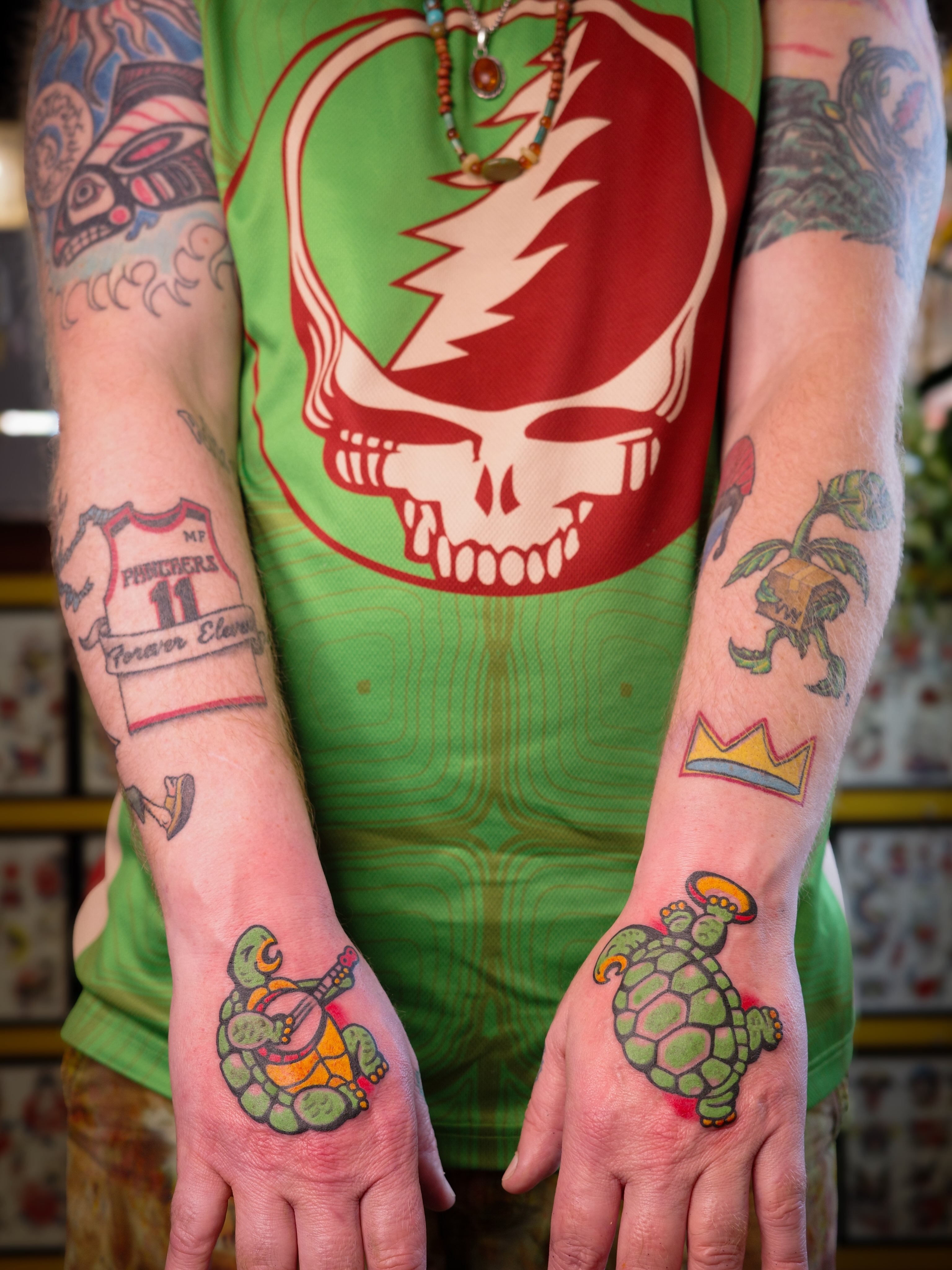 Turtles playing banjo American traditional tattoo on the hand by Danny Reed, Asheville, North Carolina