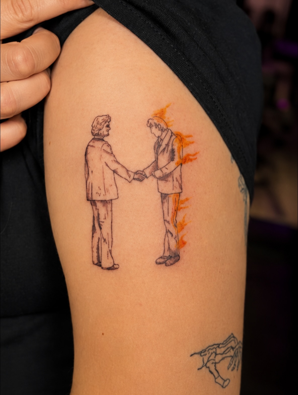 Handshake black and grey tattoo on the upper arm by Cece, Las Vegas, Nevada