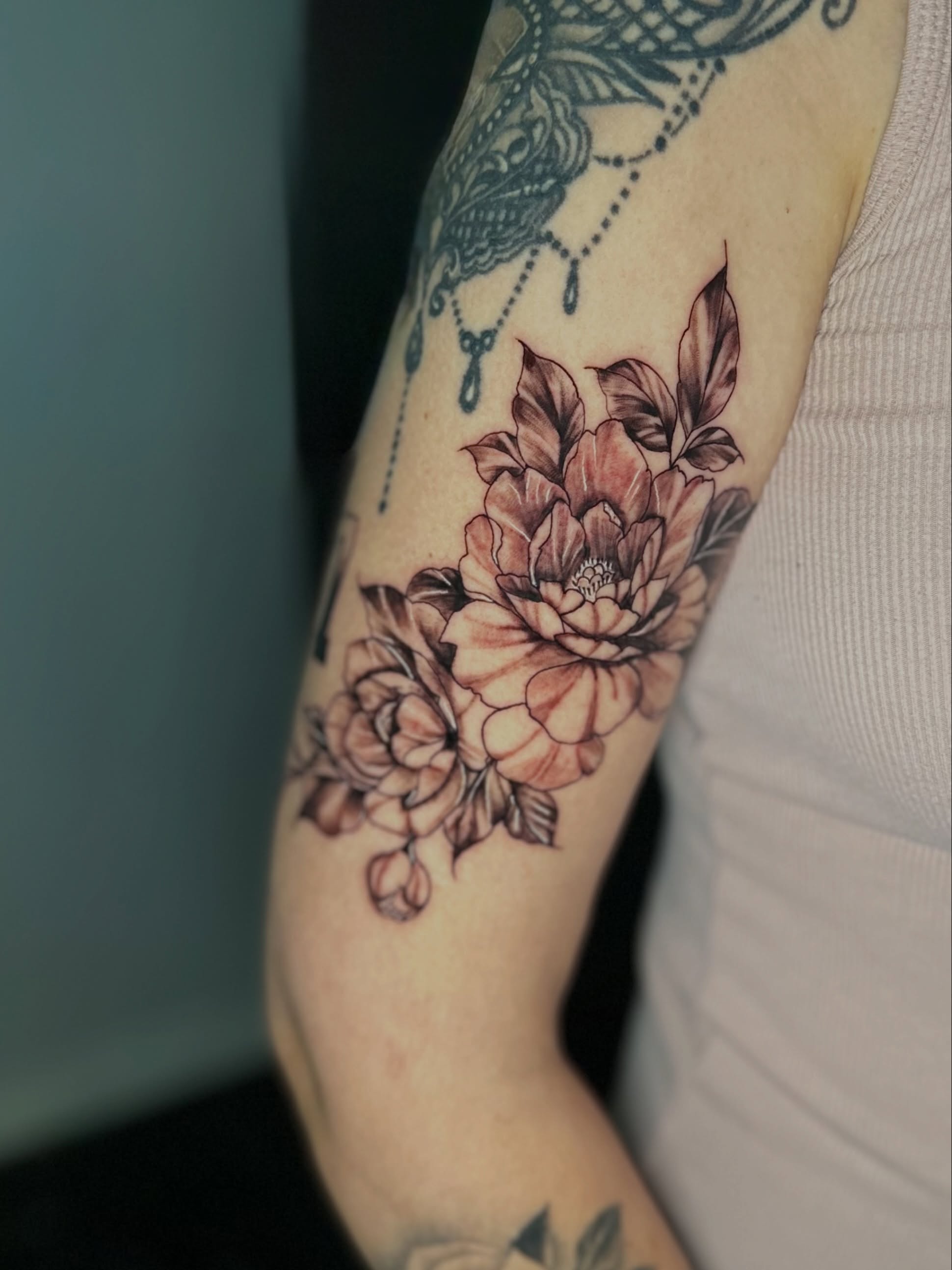 Peony flowers black and grey tattoo on the forearm by AJ