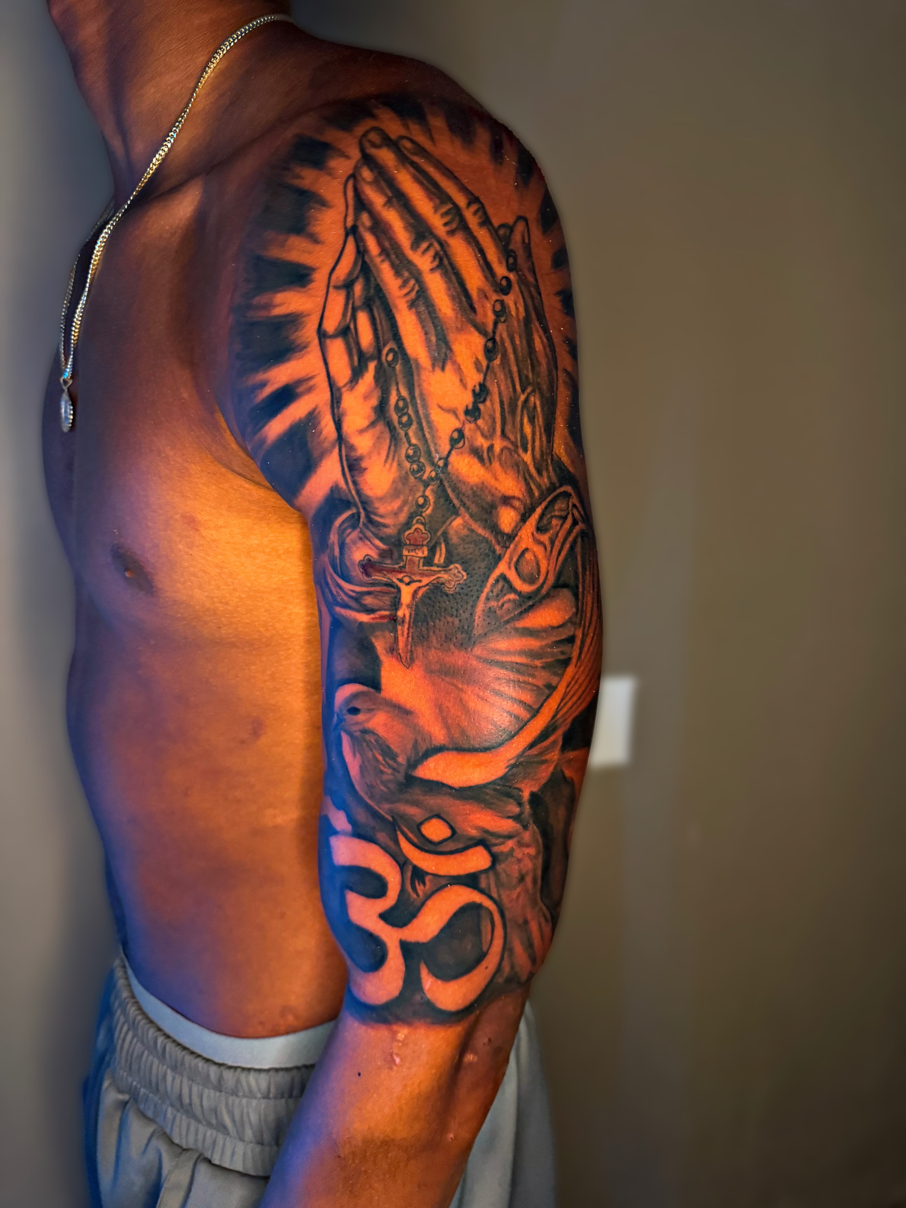Praying hands with cross realism tattoo on the forearm by Dallas Tattoo Artist📍