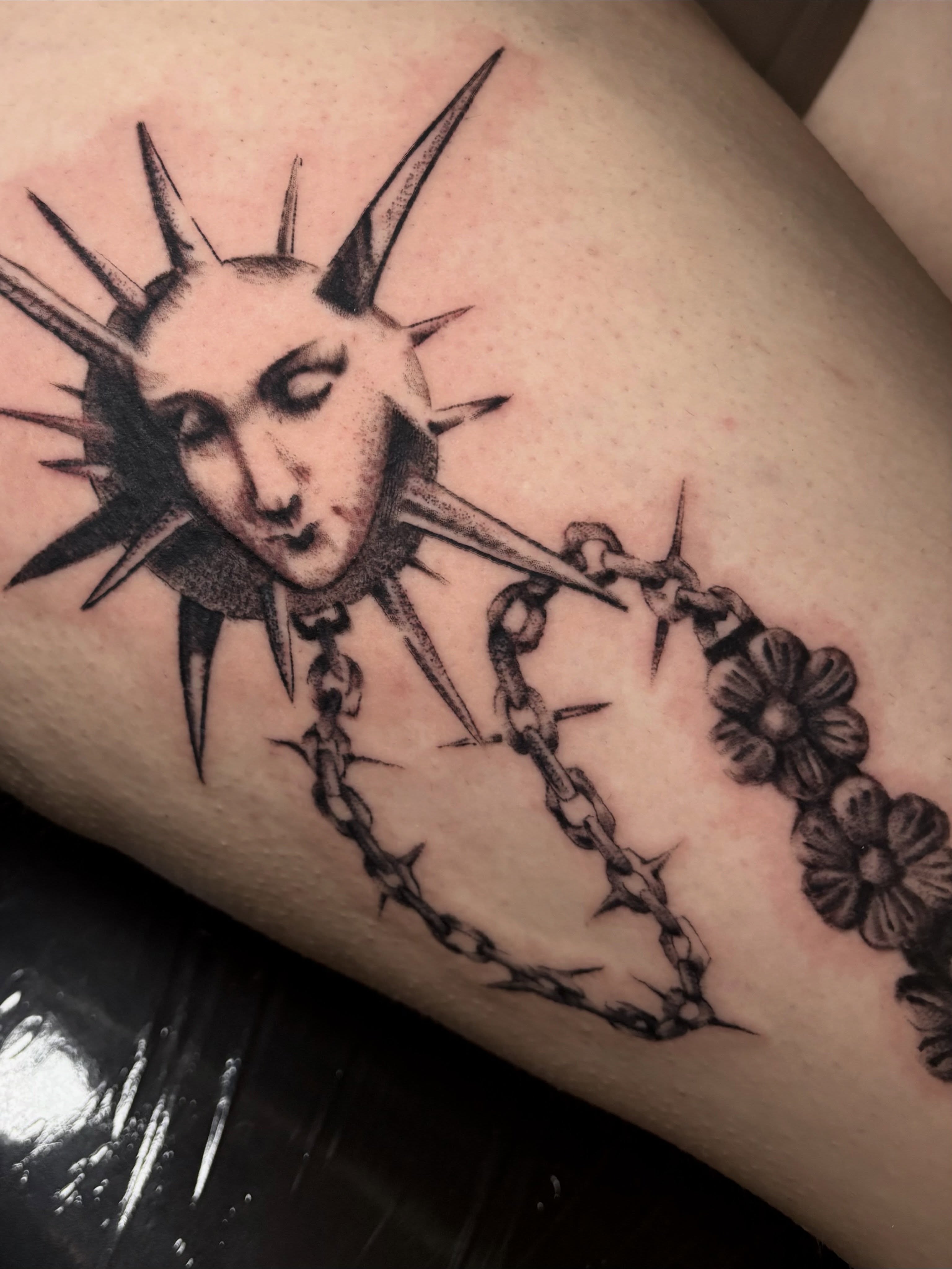 Barbed wire and flowers black and grey tattoo on the forearm by Flor, Dallas, Texas