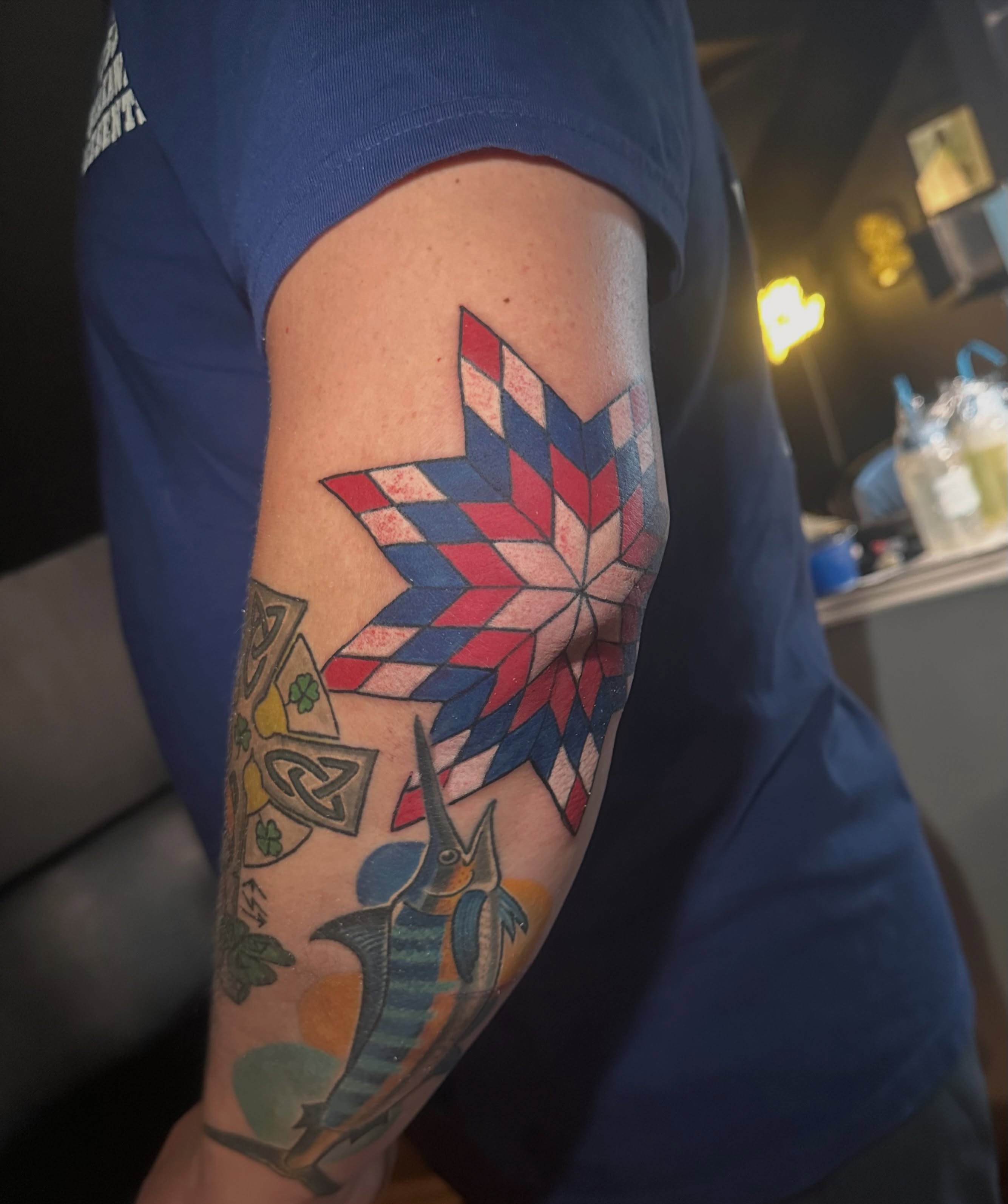 Geometric star geometric tattoo on the forearm by Cory Wasmund (blue check)