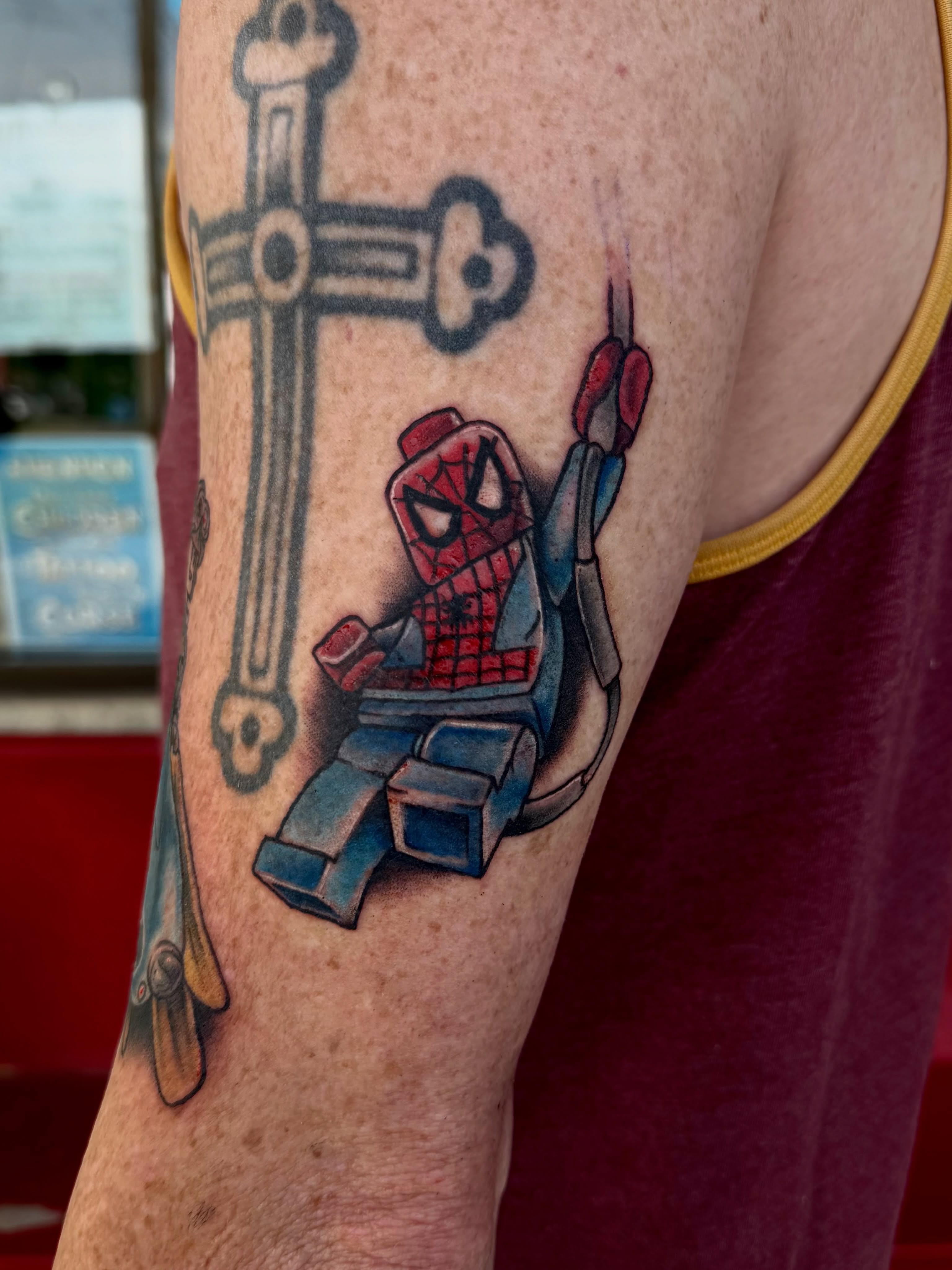 Spider-man lego American traditional tattoo on the forearm by Josh Kronauer