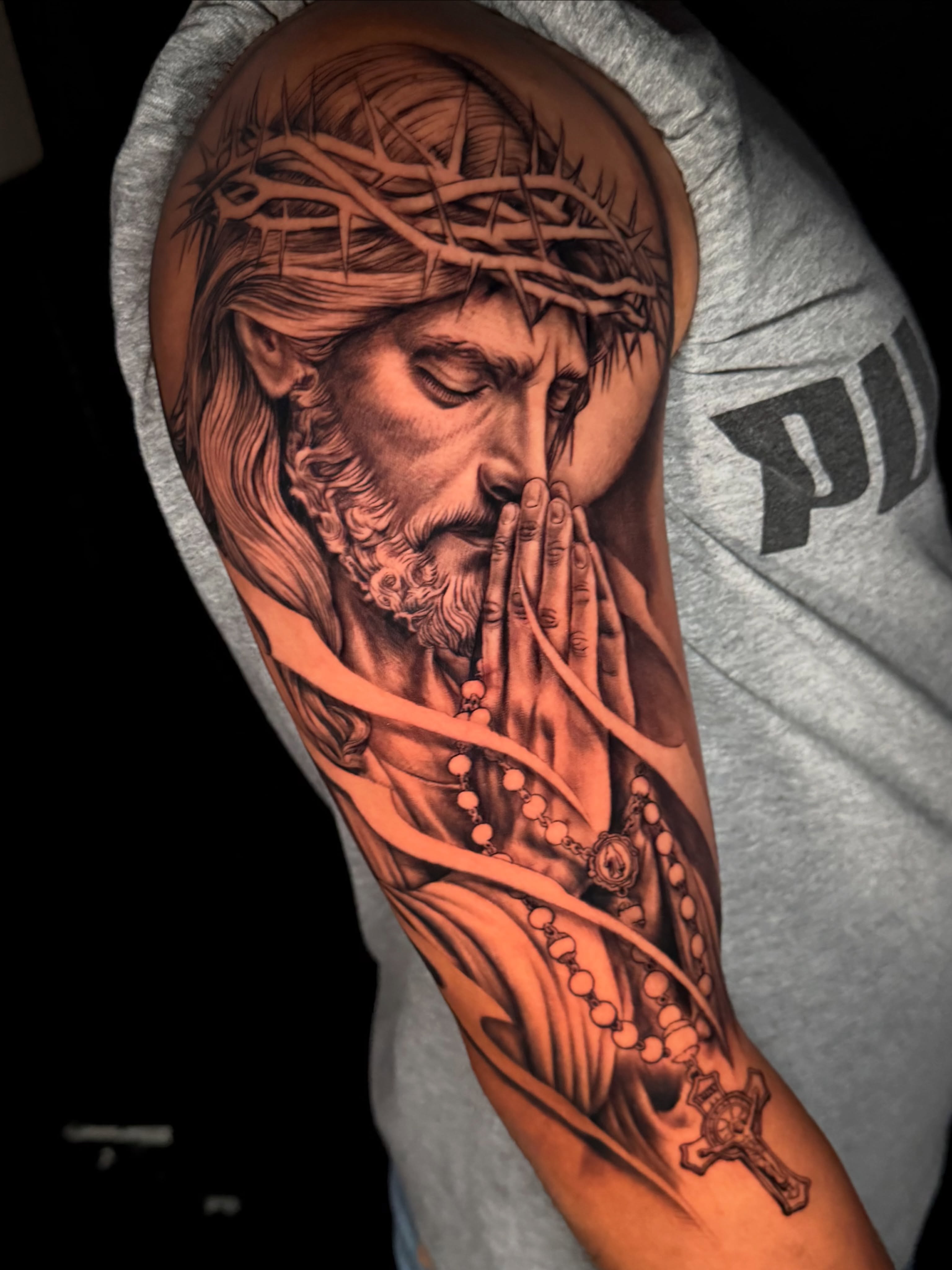 Praying jesus realism tattoo on the forearm by Omar Sheriff Herrera