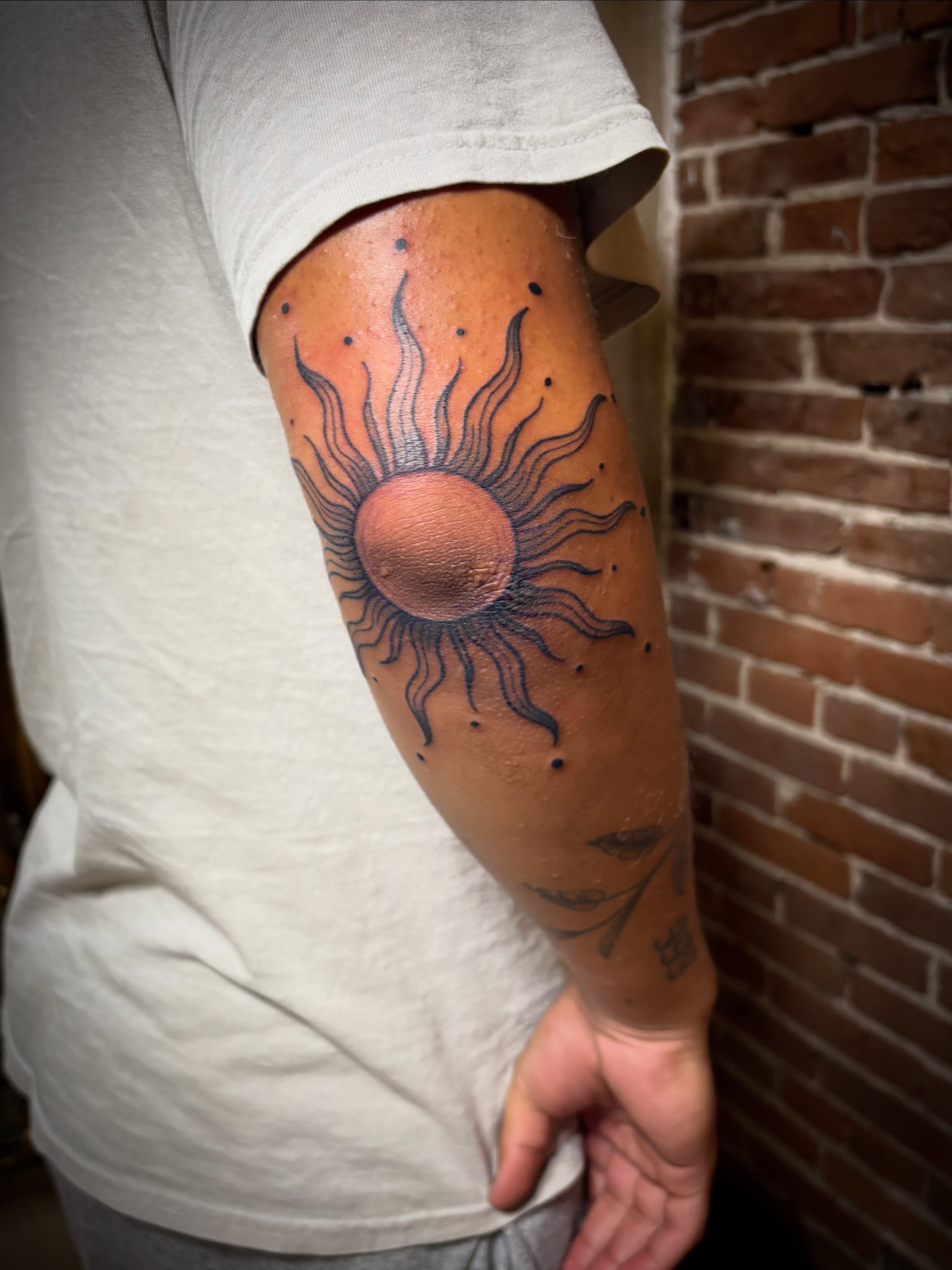 Sun dotwork tattoo on the forearm by Tattoo Artist, Kansas City, Missouri