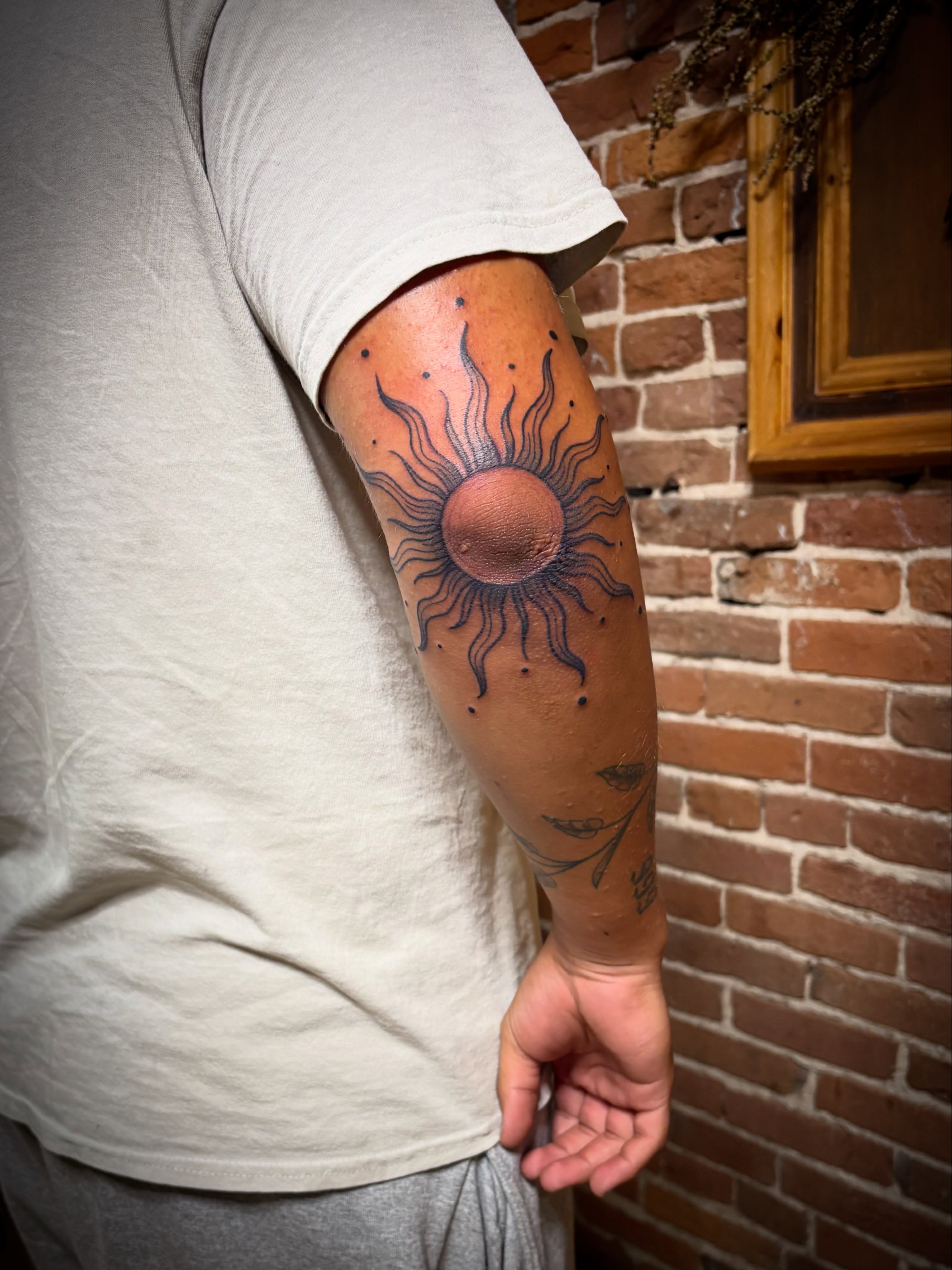Sun dotwork tattoo on the forearm by Tattoo Artist, Kansas City, Missouri