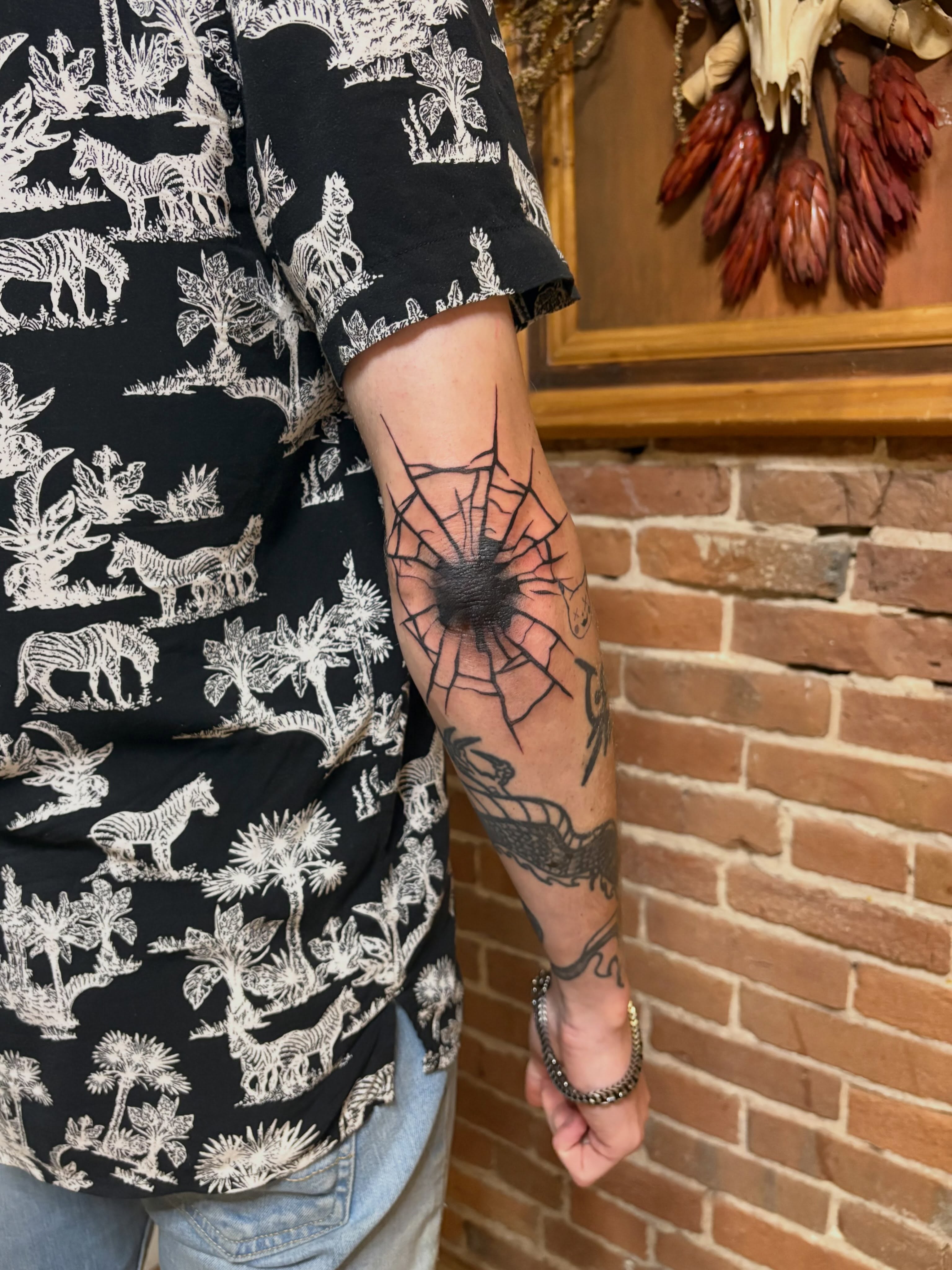 Spider web black and grey tattoo on the forearm by Tattoo Artist, Kansas City, Missouri