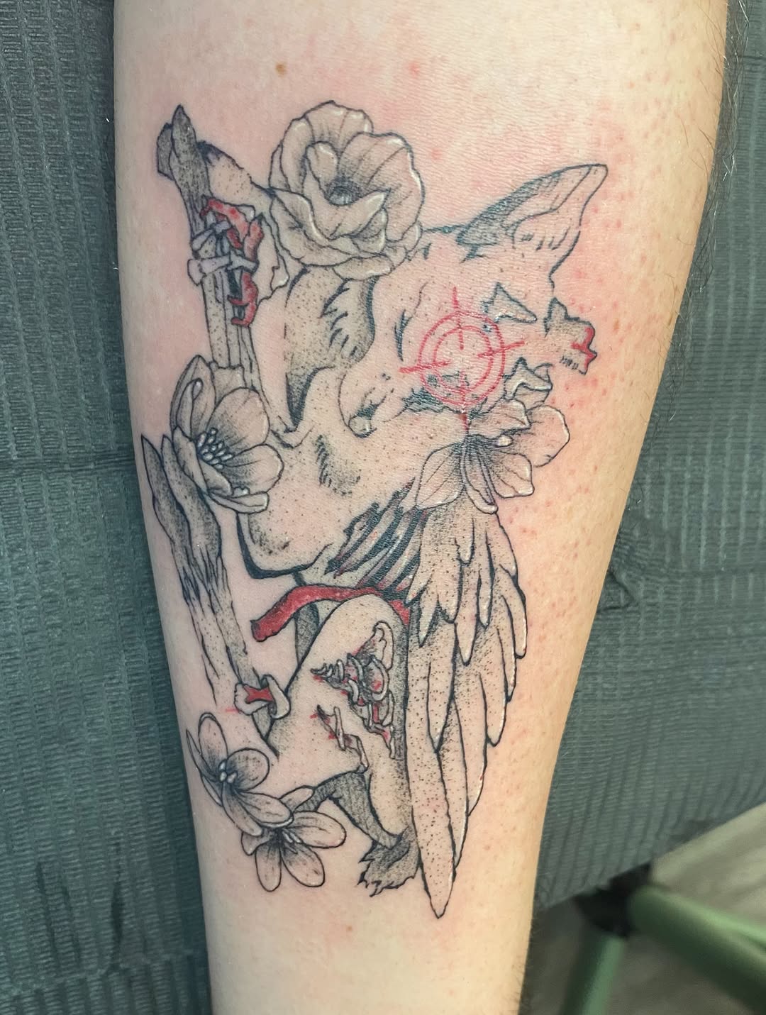 Animal skull with wings and flowers tattoo on the forearm by MD Ariel🦷