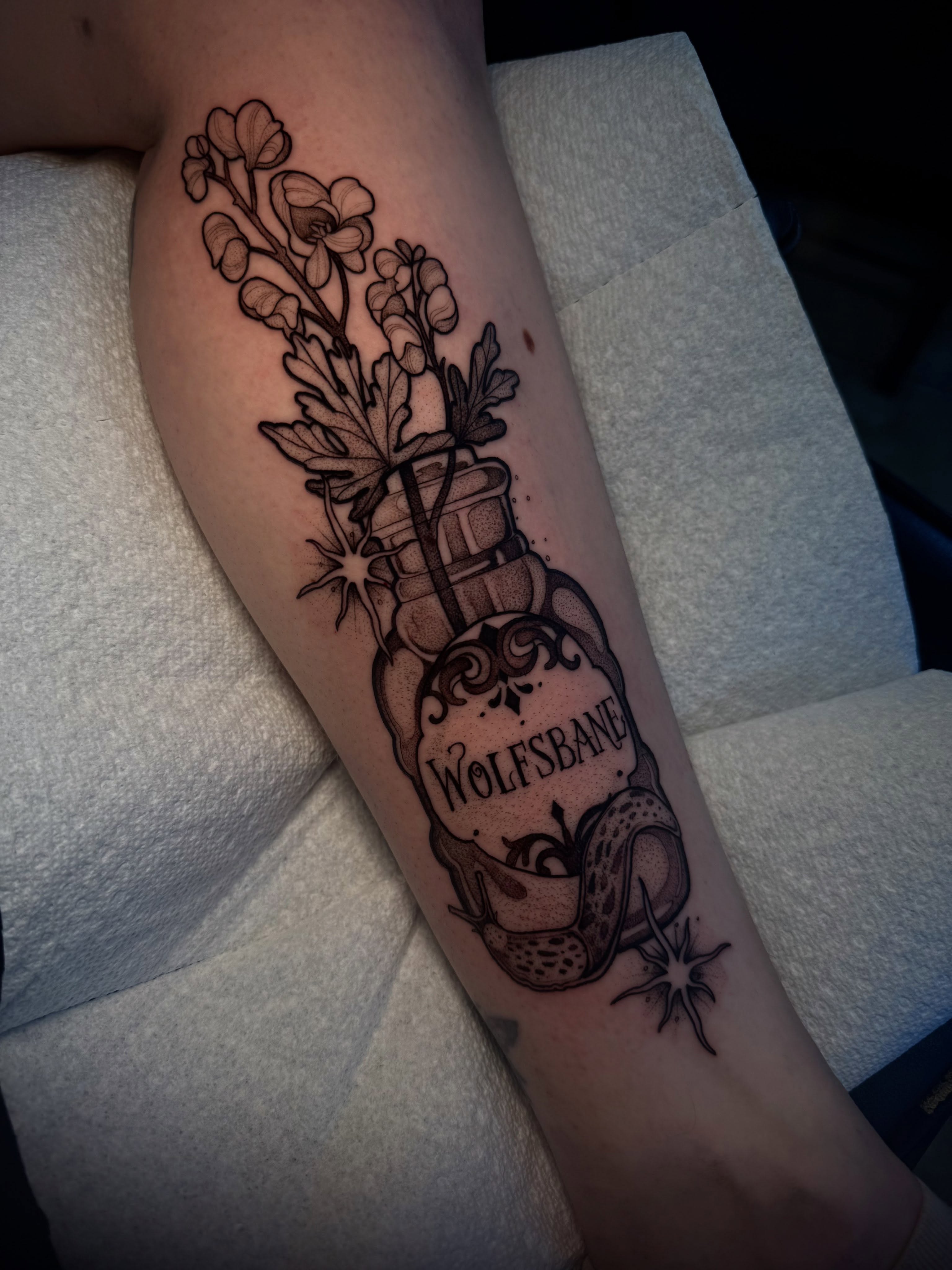 Wolfbane potion bottle black and grey tattoo on the forearm by H A N N A H, Colorado Springs, Colorado