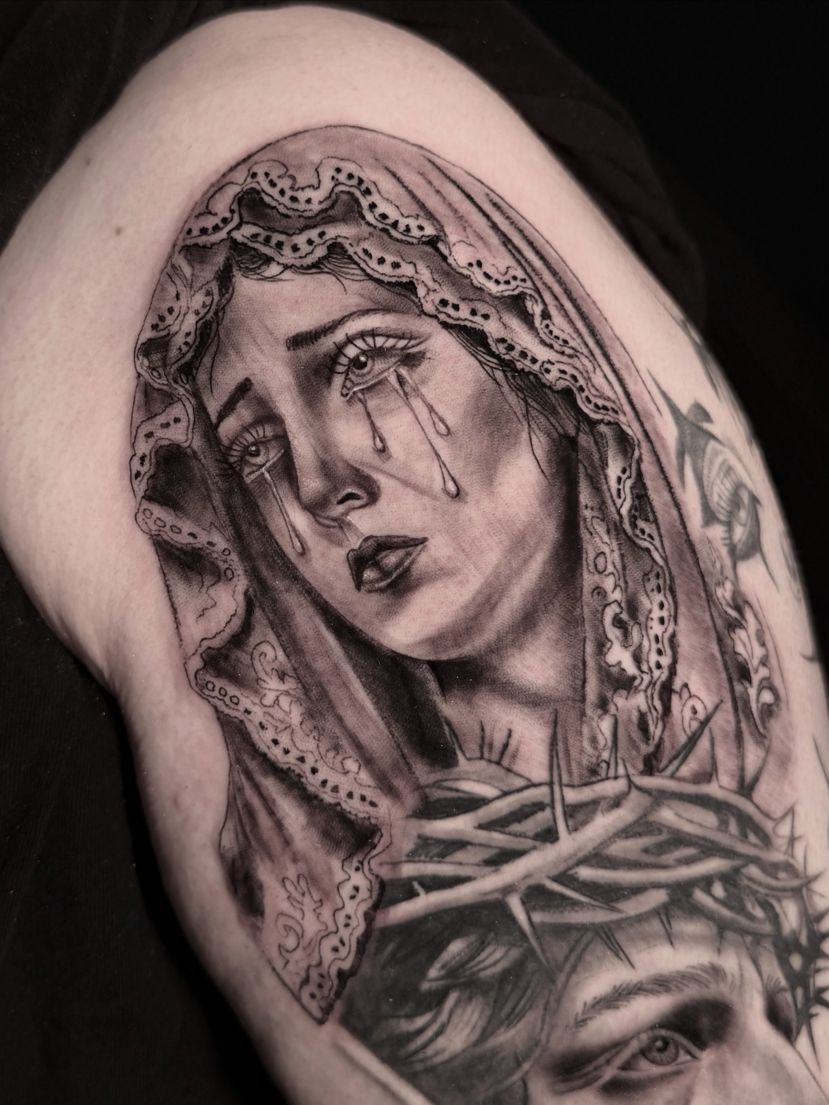 Religious figure realism tattoo on the shoulder by Alex Cantor