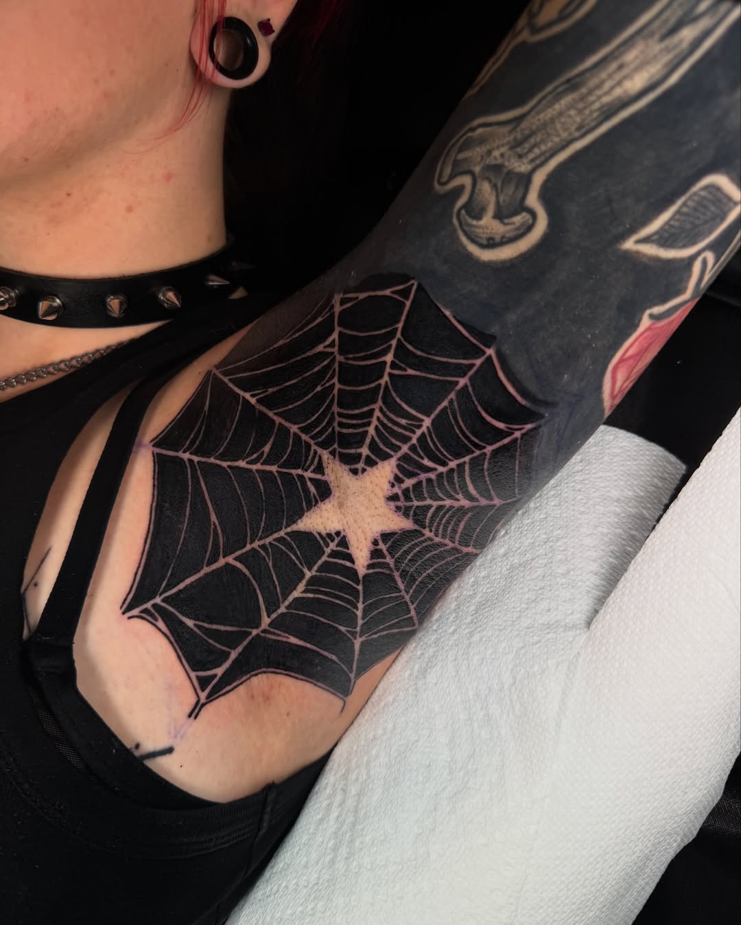 Spider web geometric tattoo on the forearm by Beau Zeis
