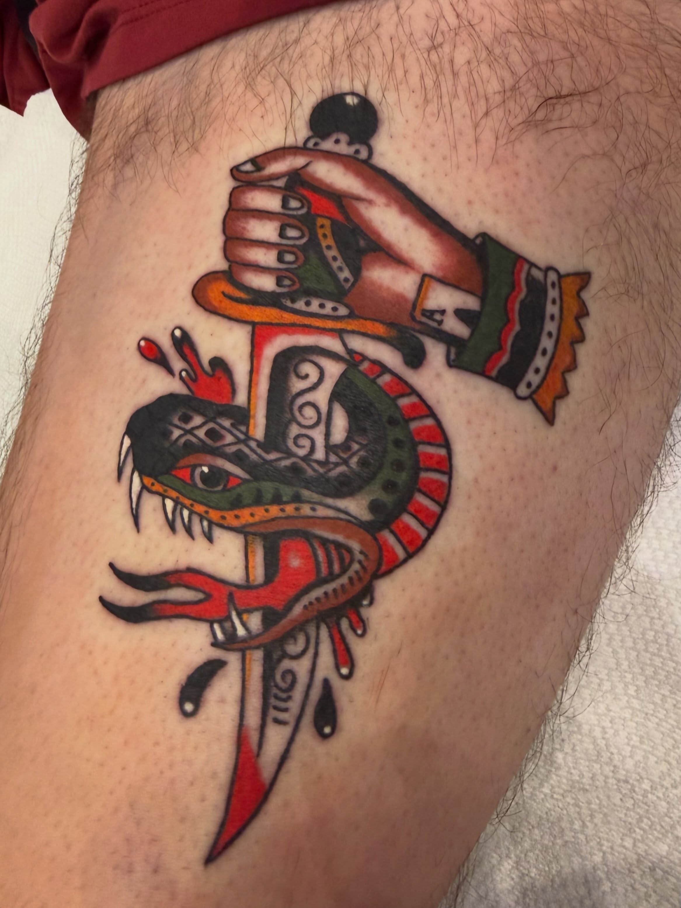 Snake and dagger American traditional tattoo on the thigh by David Evans
