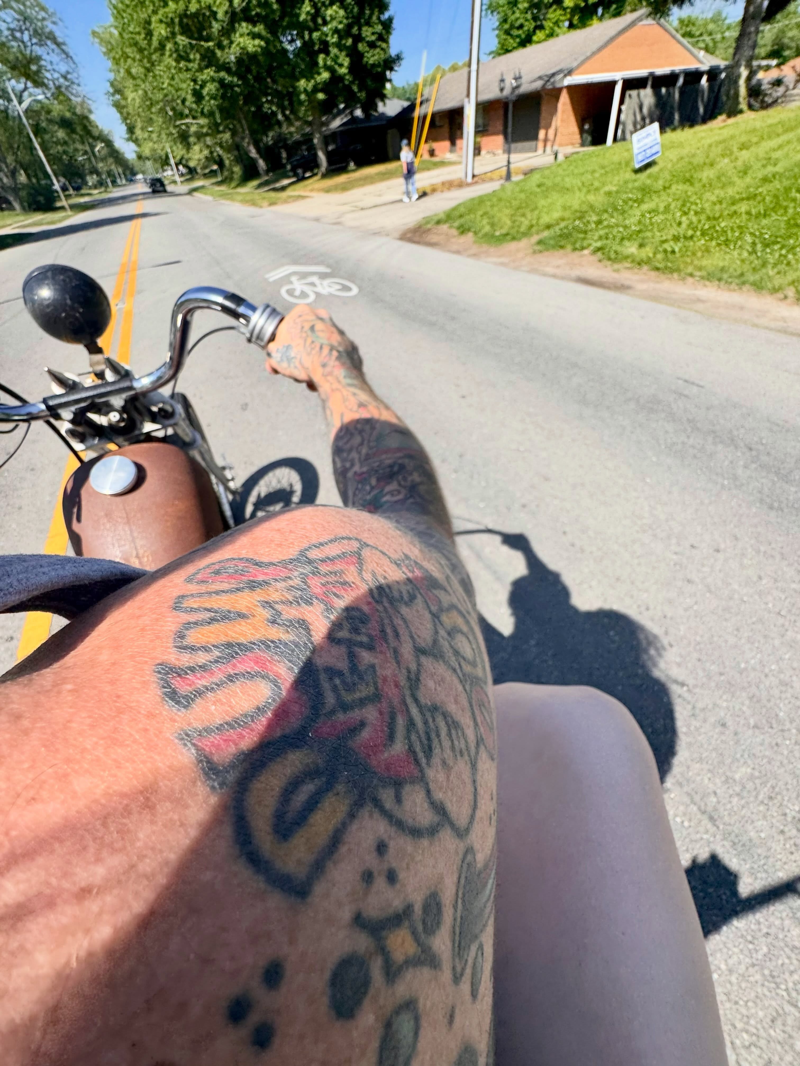 Flaming text American traditional tattoo on the thigh by Atom Aker