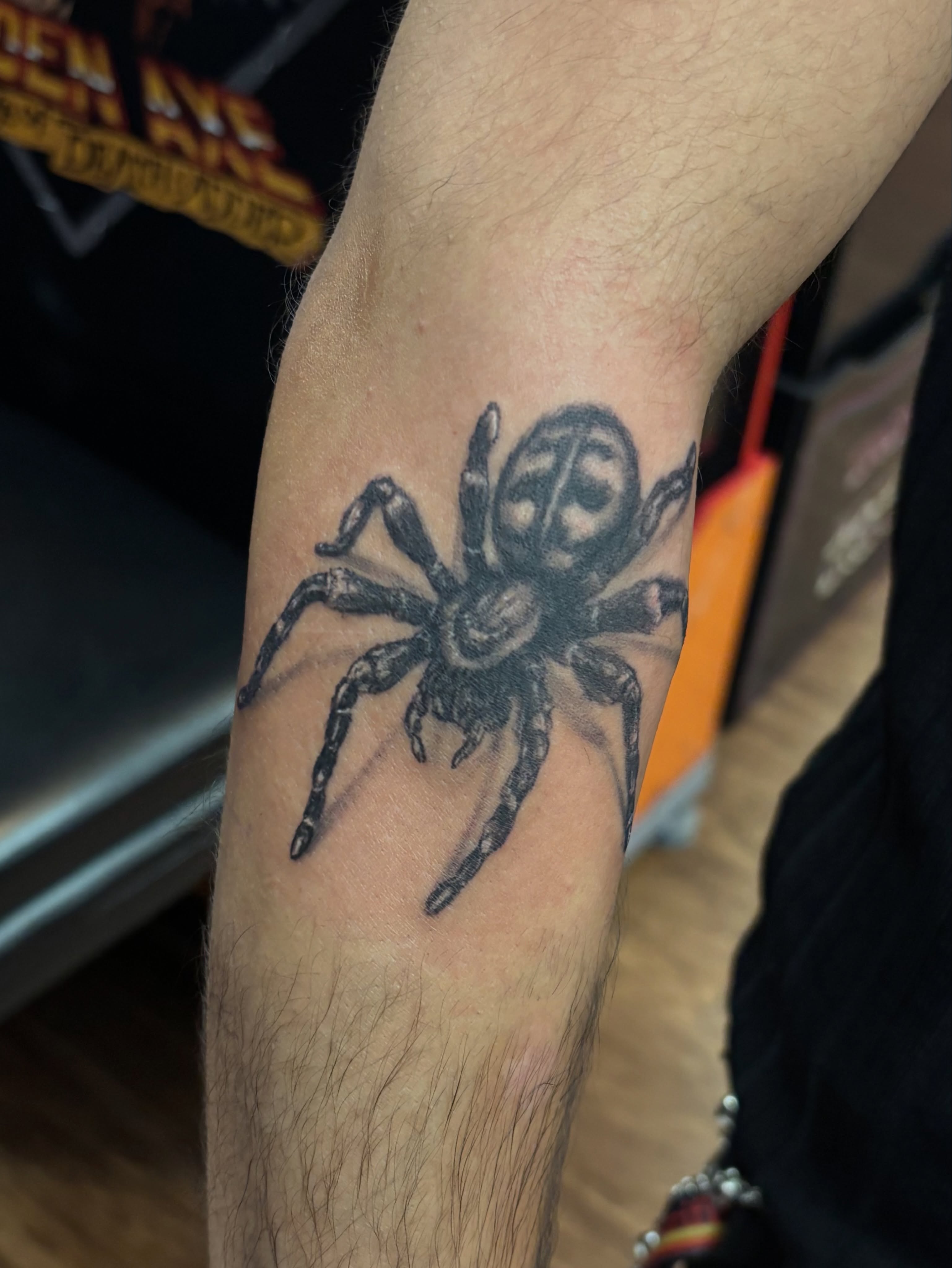 Spider black and grey tattoo on the forearm by Thom Johns-Green
