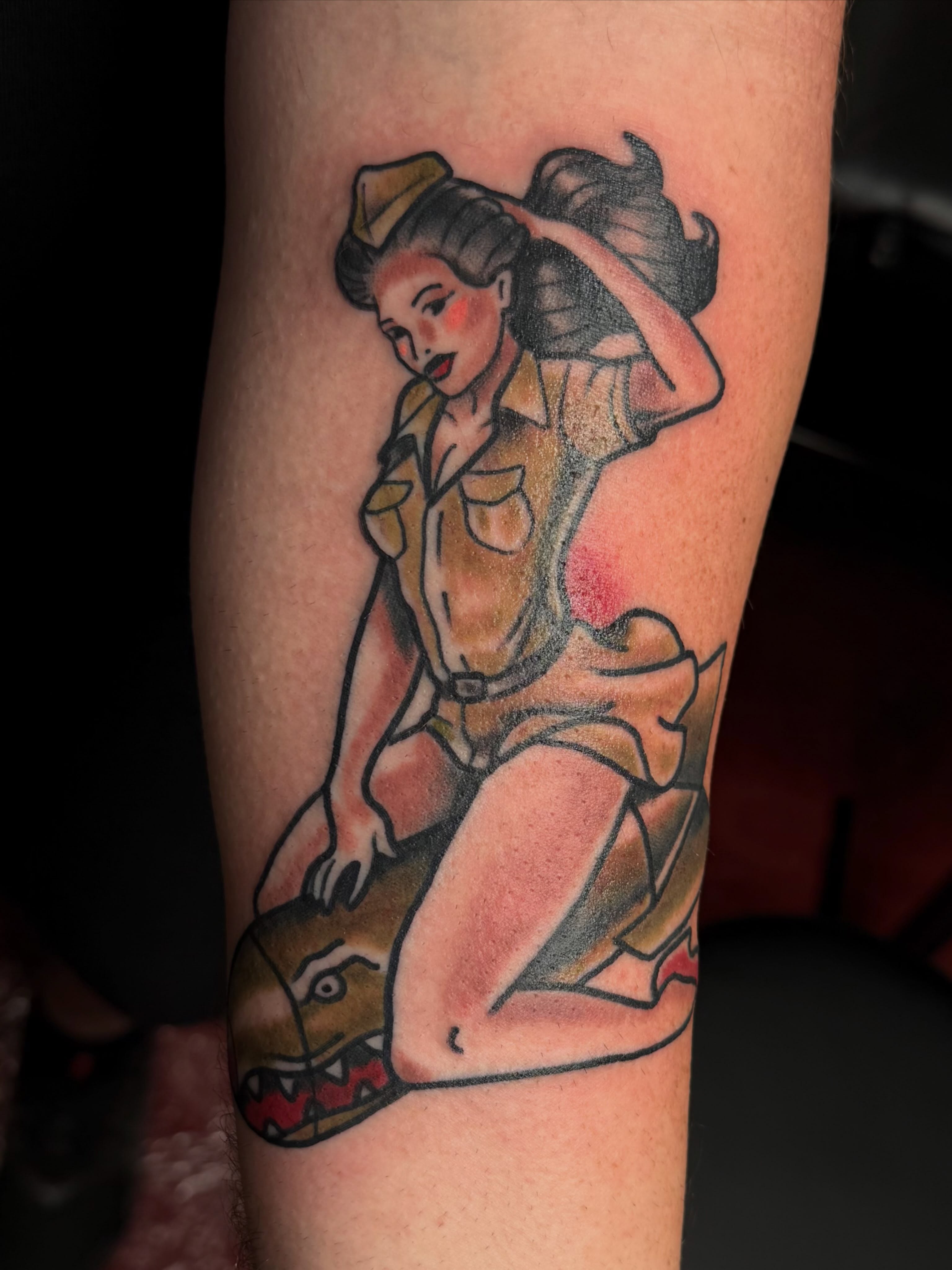 Pin-up girl American traditional tattoo on the forearm by Chris Smiseck