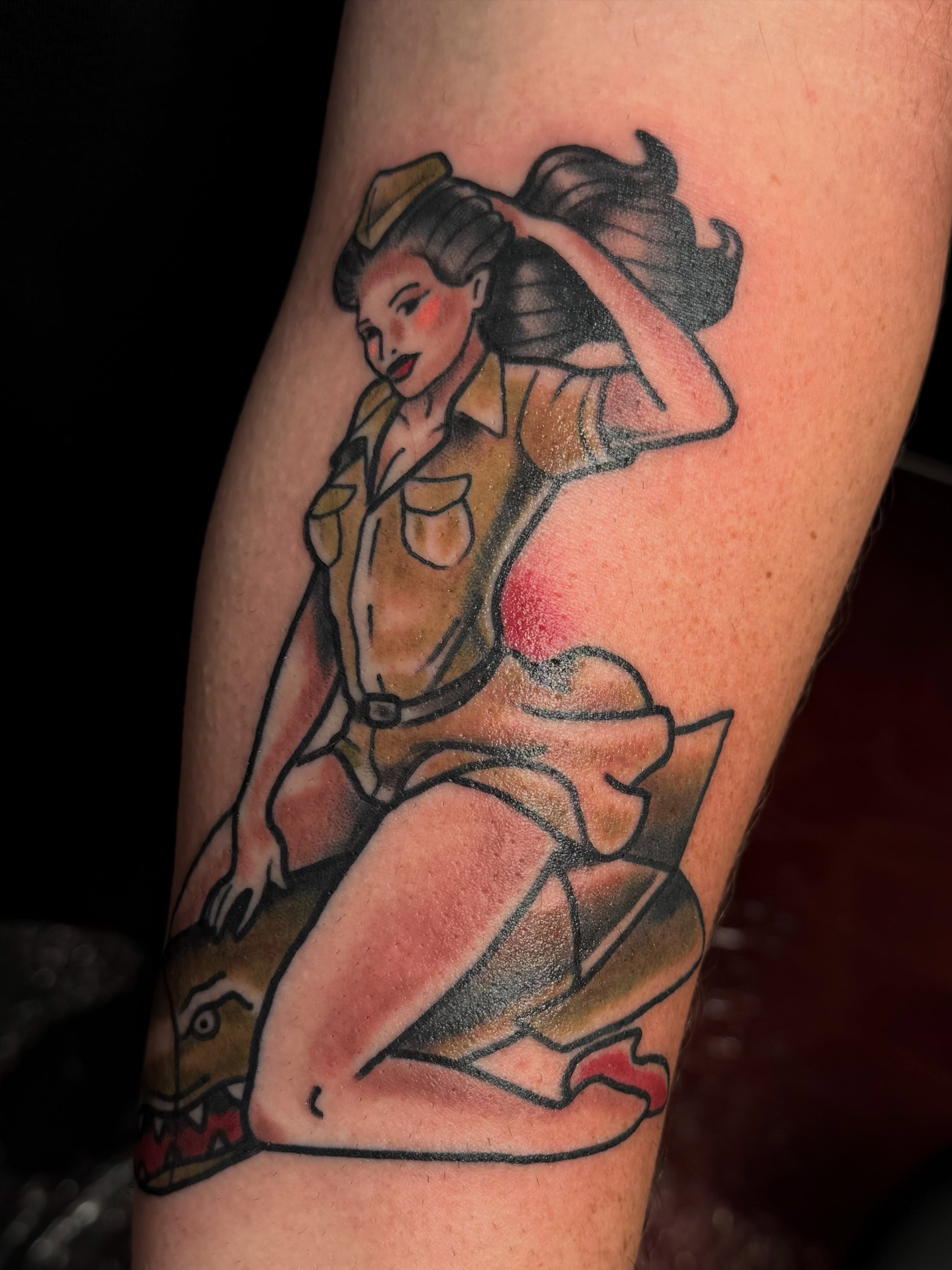 Pin-up girl American traditional tattoo on the forearm by Chris Smiseck