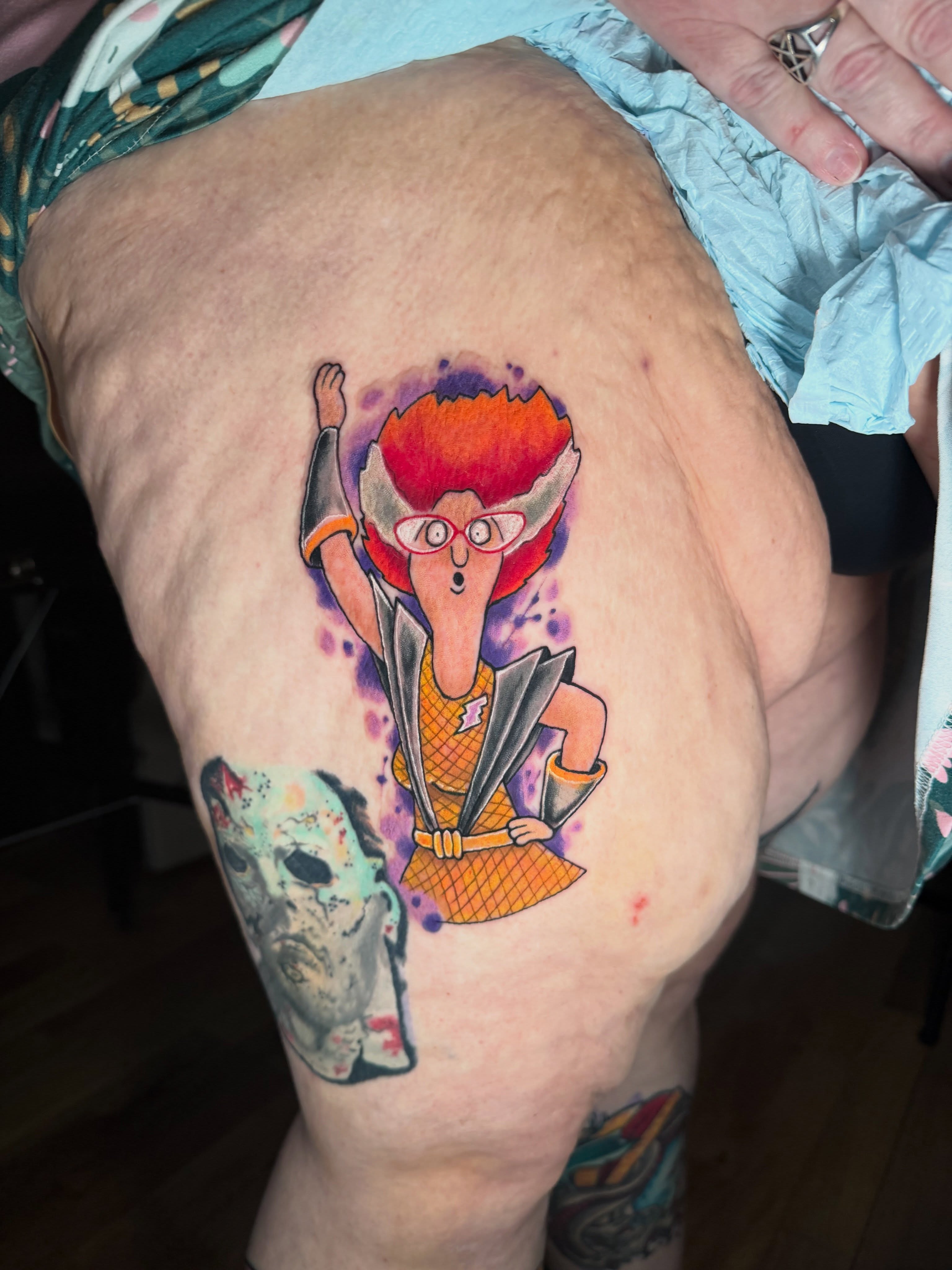 Character illustrative tattoo on the thigh by Loki Shane DeFriece