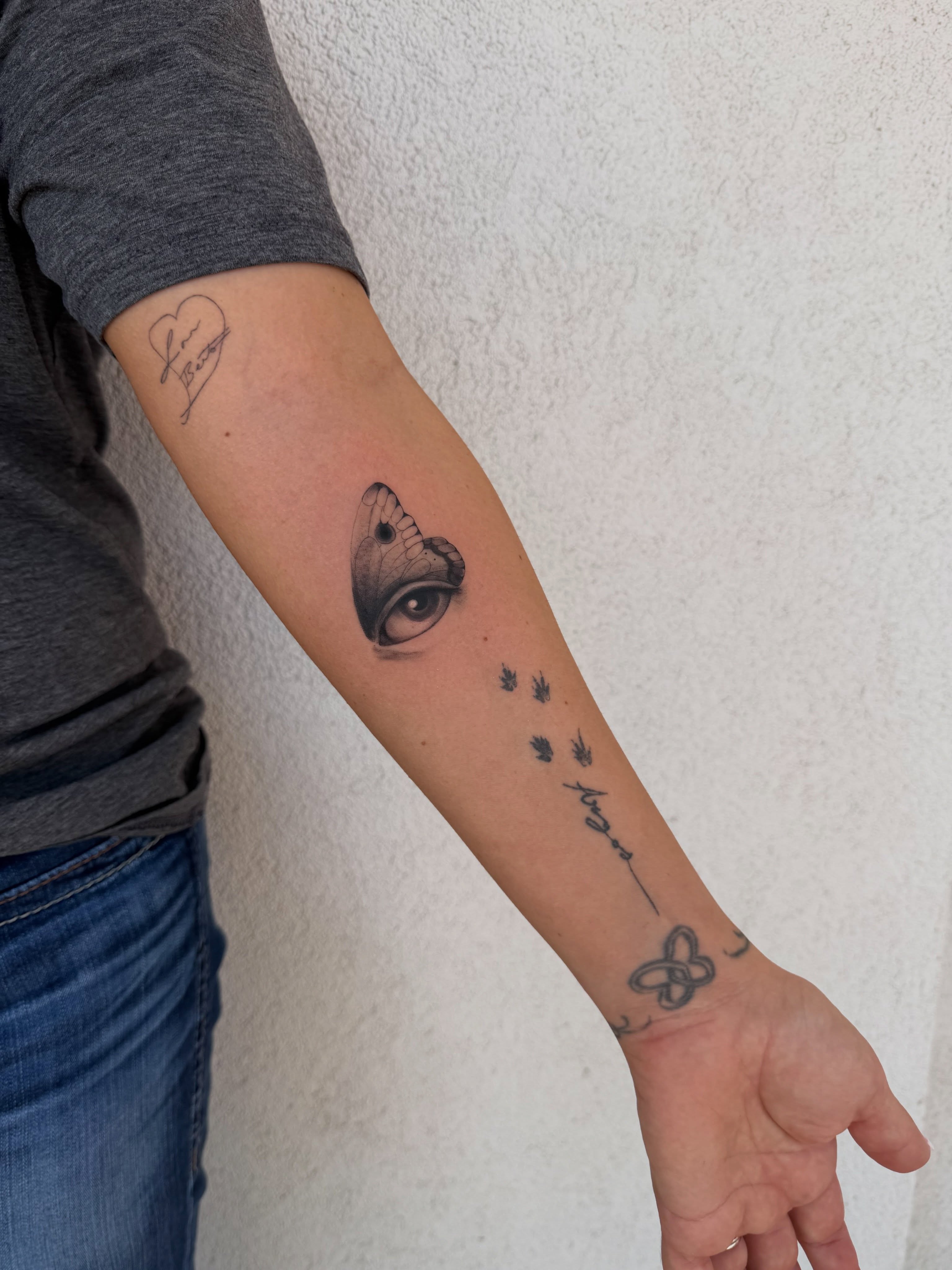 Eye and butterfly realism tattoo on the forearm by Jacksyn, Plano, Texas