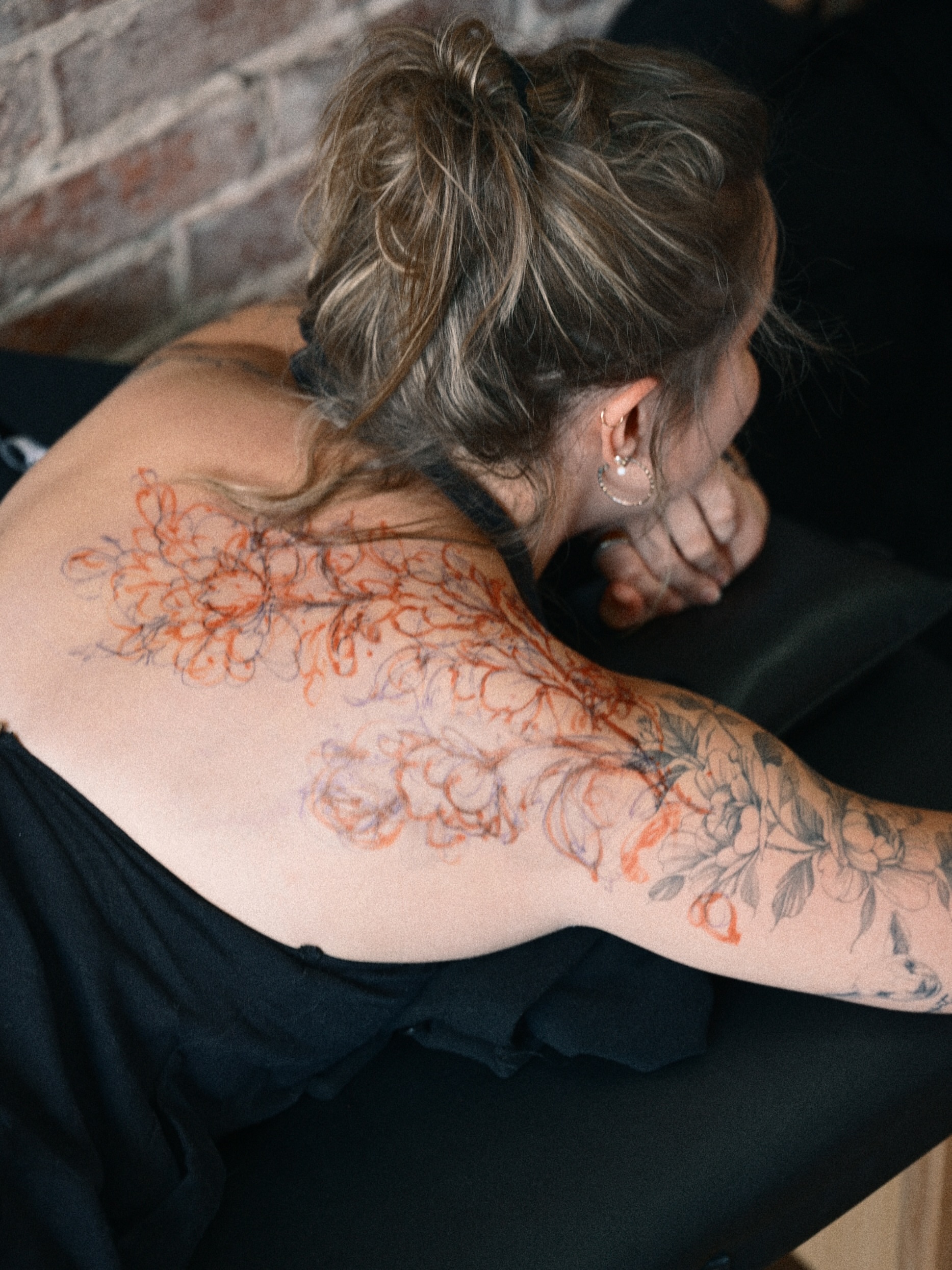 Floral new school tattoo on the back by Brad Simmons