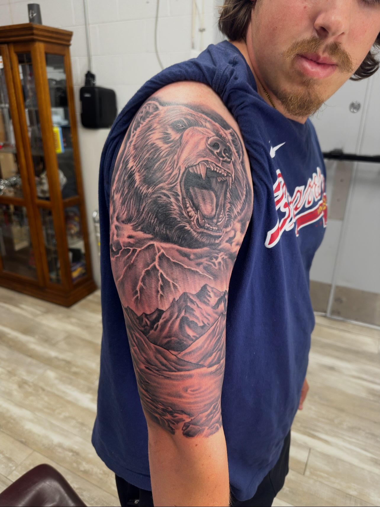 Roaring bear realism tattoo on the upper arm by Isaac Ortiz-Riendeau
